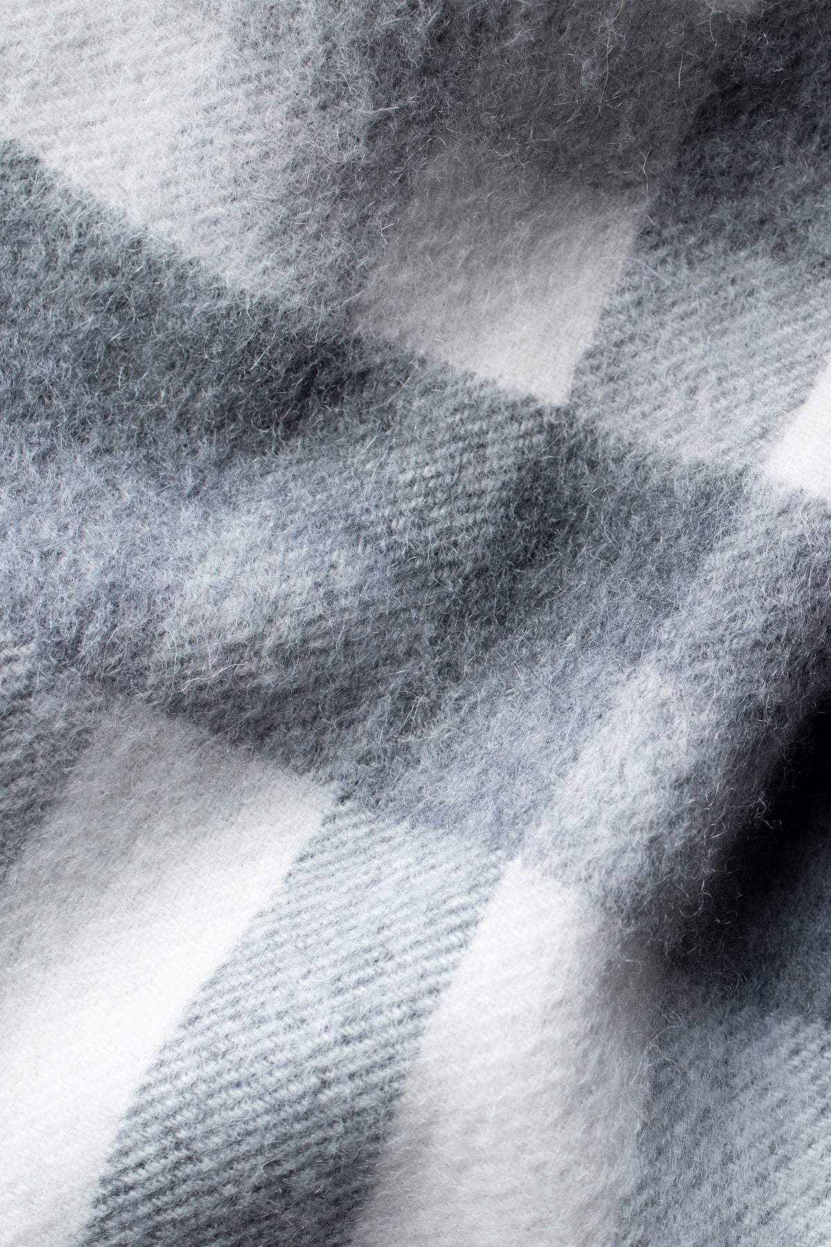 Close-up of Stepping Check Cashmere Wrap in Monochrome showing soft brushed texture and grey-and-white check pattern