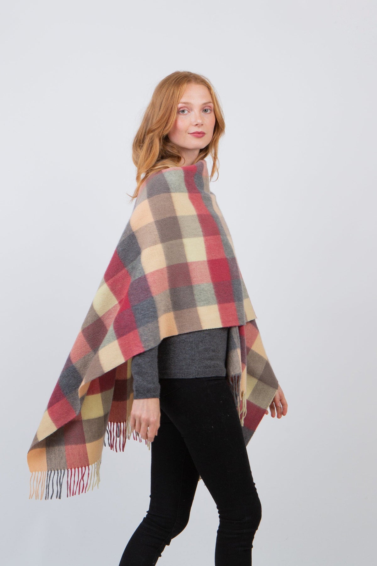 5 Square Cashmere Wrap in Grey Rose worn draped over shoulders, showing plaid pattern with fringed edges