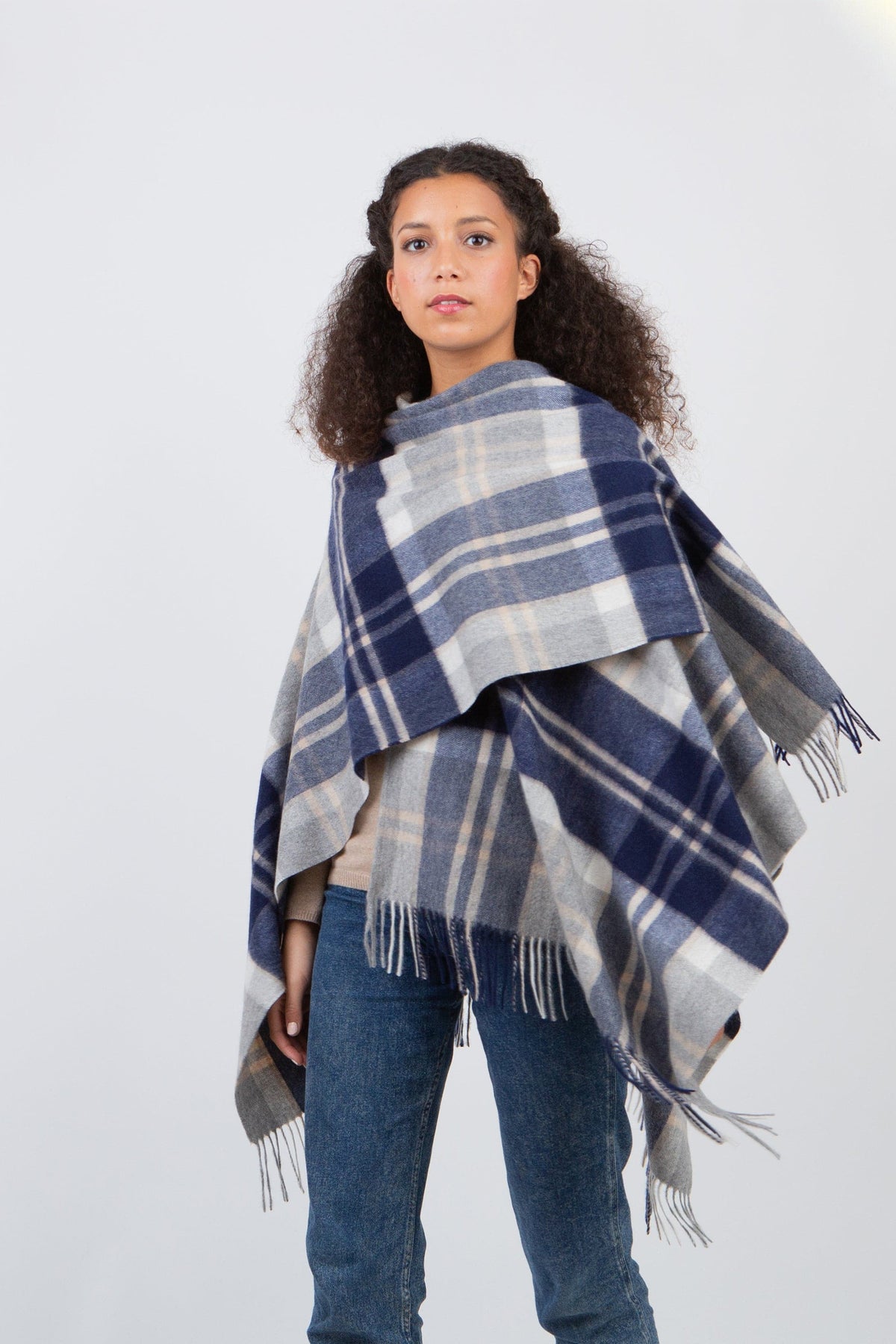 Heritage Tartan Cashmere Wrap in Silver Bannockbane draped over shoulders, navy and grey plaid pattern with fringed edges