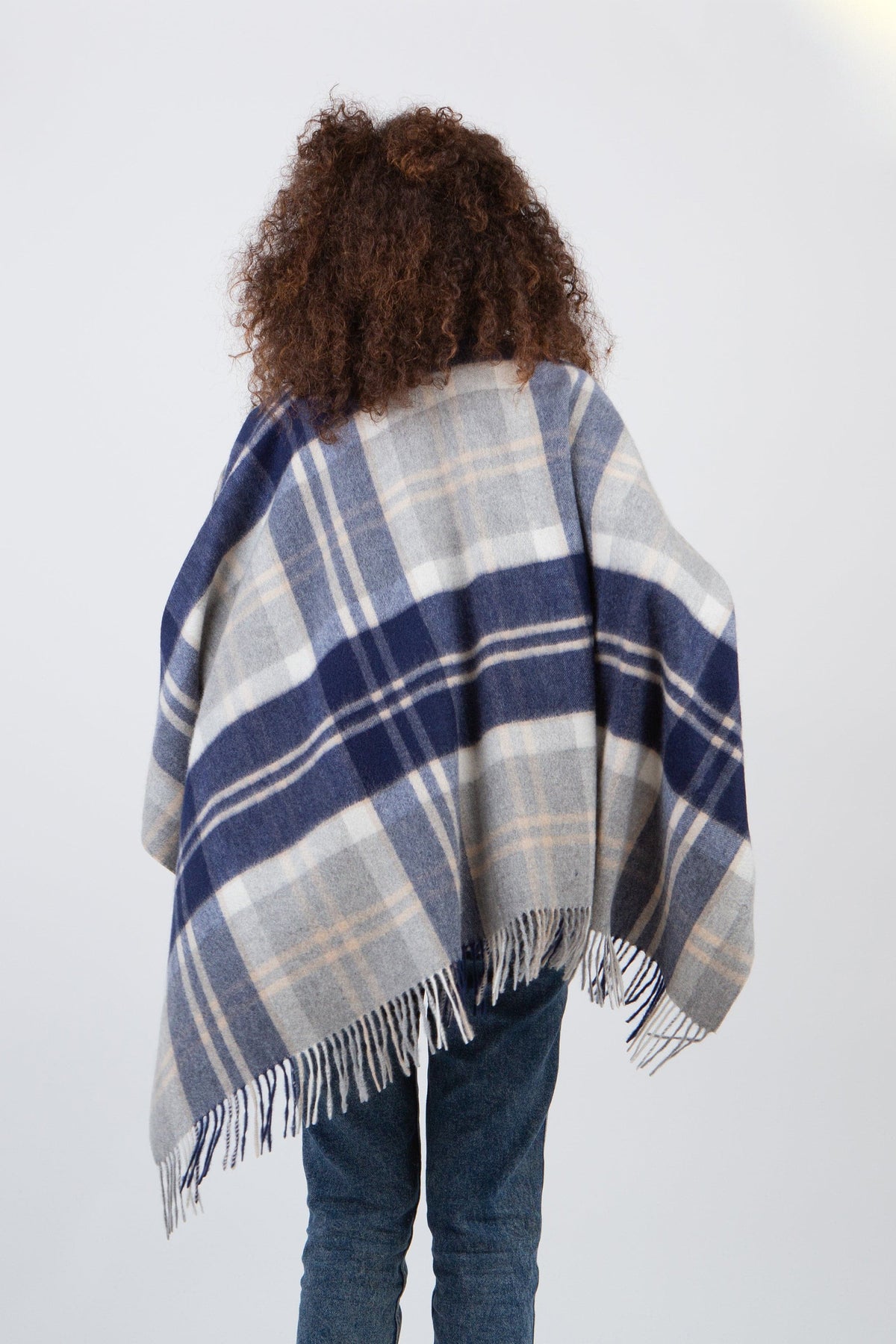 Back view of Heritage Tartan Cashmere Wrap in Silver Bannockbane, showing full plaid drape and fringed hem on model