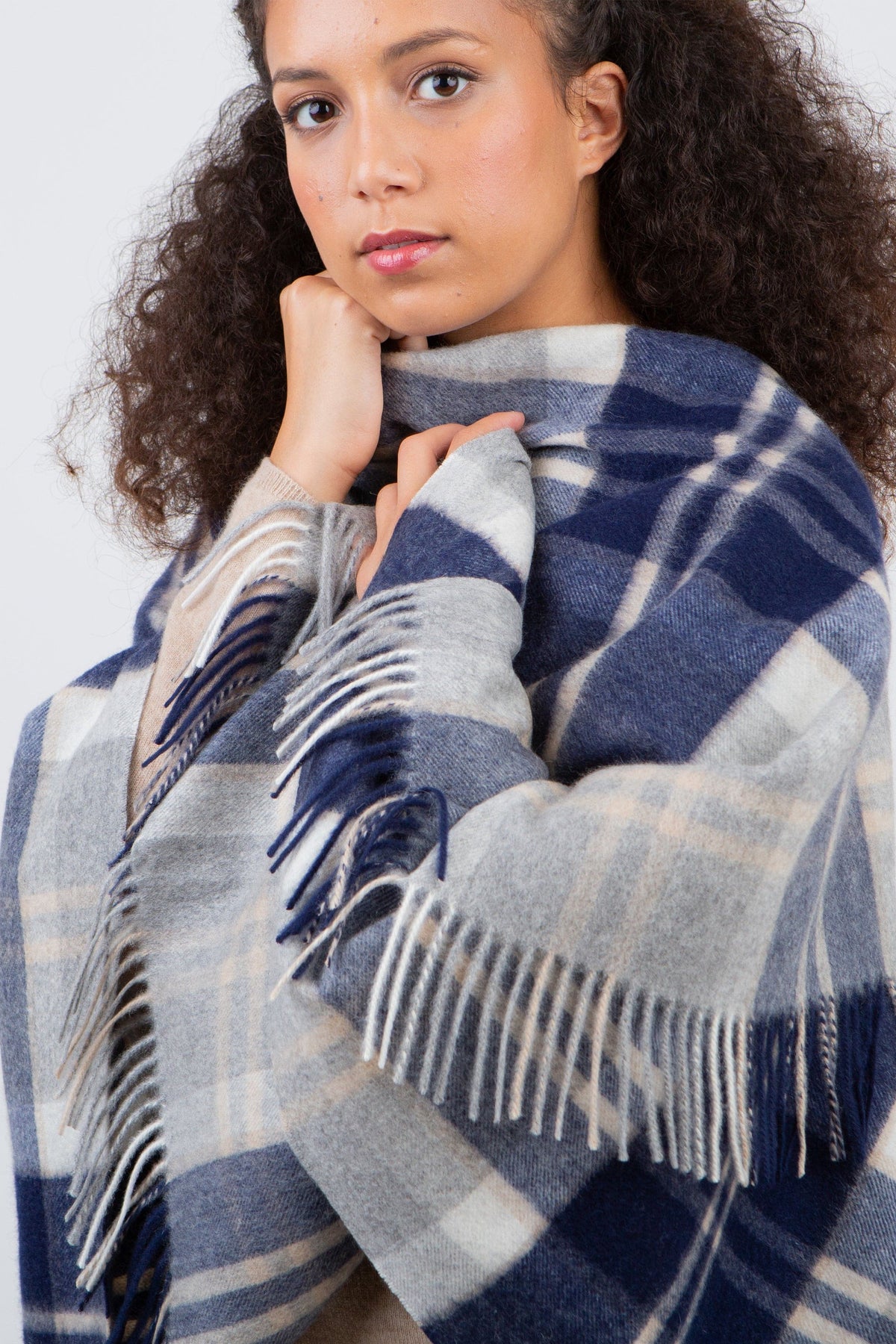 Heritage Tartan Cashmere Wrap in Silver Bannockbane worn draped over shoulders, showing fringed edges and navy-grey plaid pattern