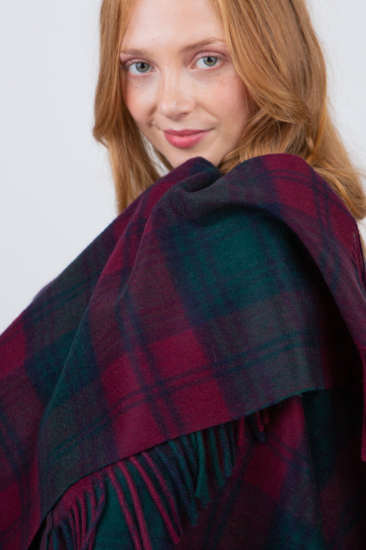 Model wrapping Heritage Tartan Cashmere Wrap - Lindsay around shoulders, showing soft brushed texture and fringed edge detail
