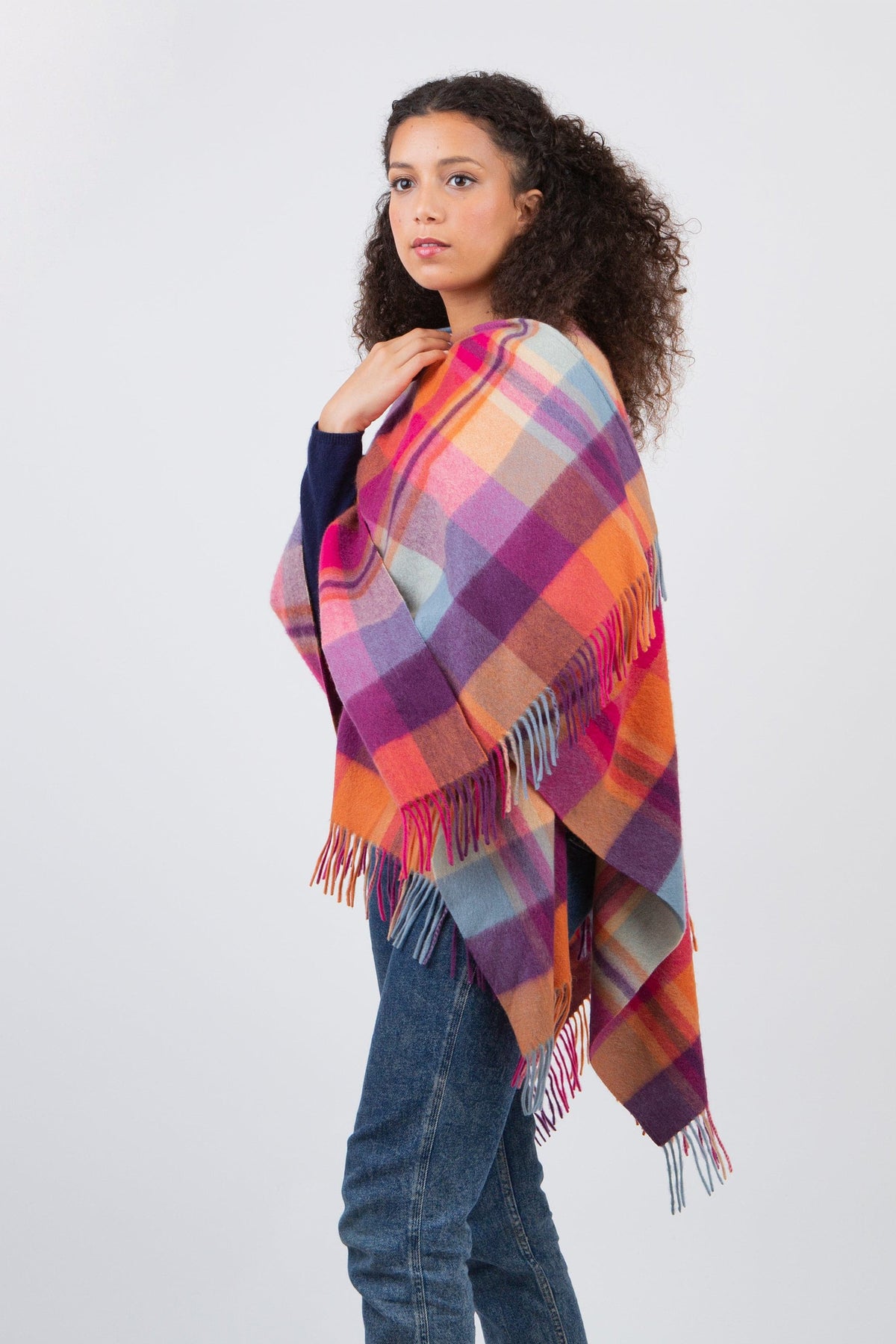 Square Check Lambswool Wrap in Orient Ginger shown draped over shoulders, side view highlighting multicolour plaid pattern and fringe detail