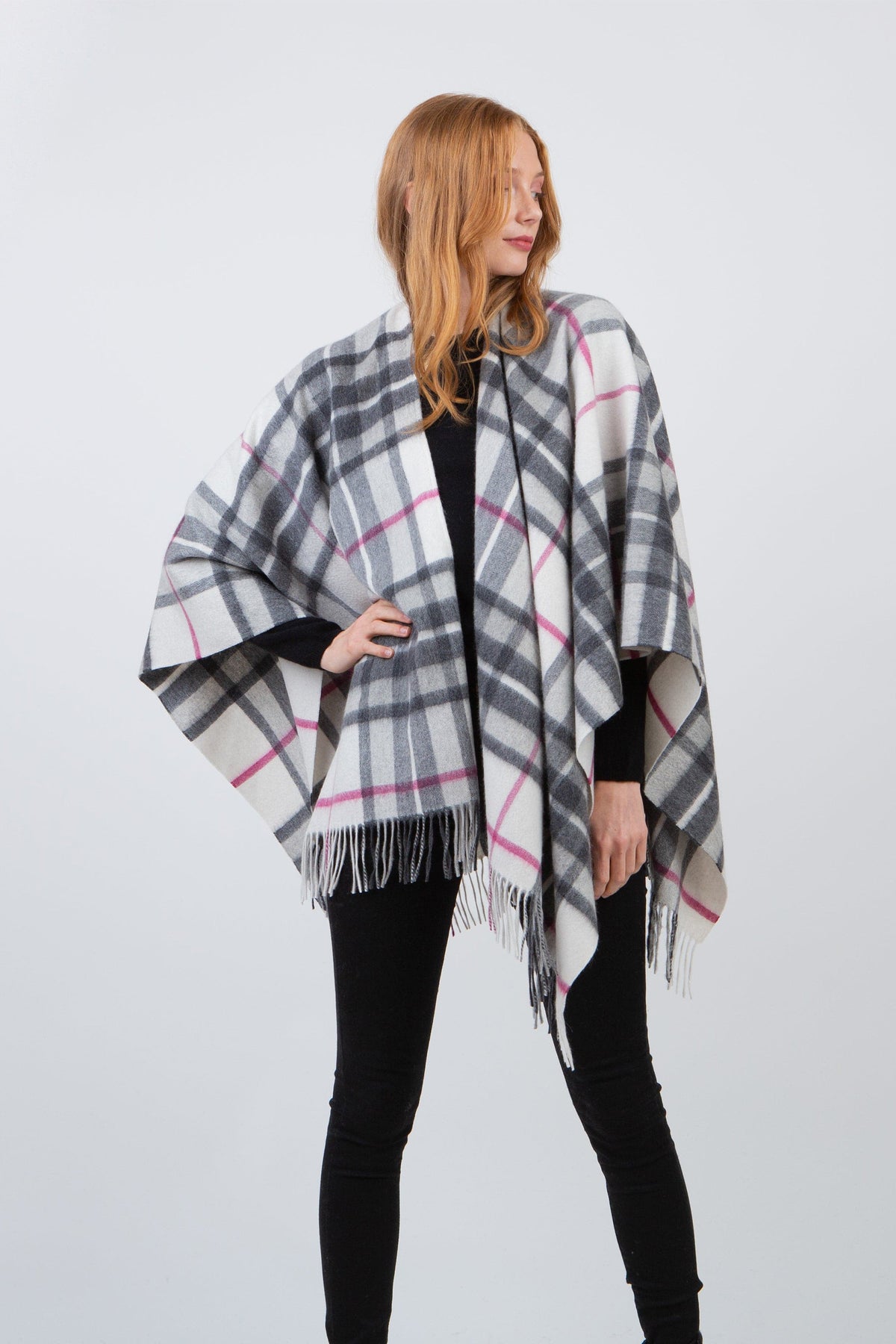 Model wearing Scotty Thompson Lambswool Wrap in White, front view showing grey and pink plaid pattern with fringed hem