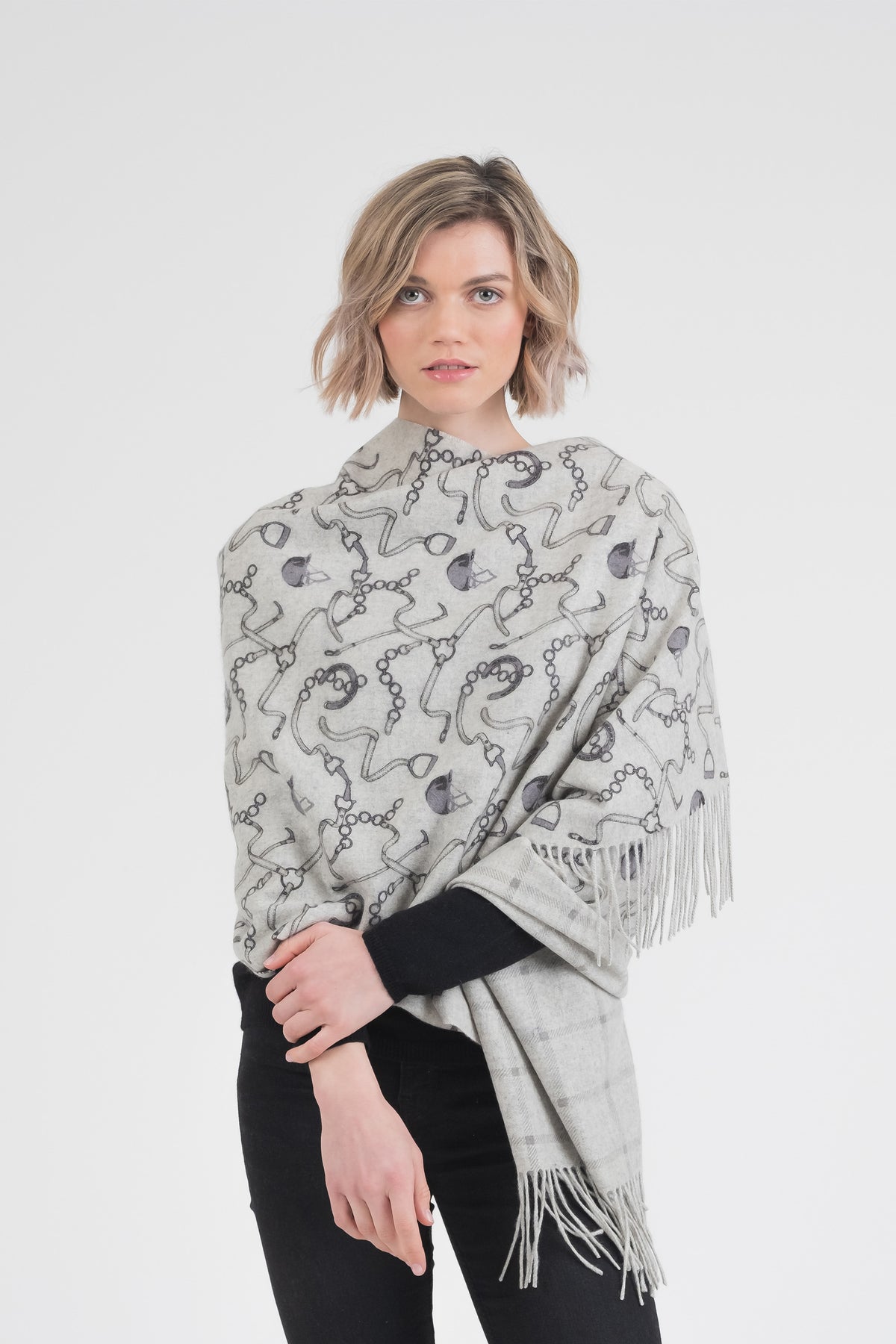 Equestrian Cashmere Double Sided Stole in grey with dark equestrian chain print, fringed edges, worn draped over shoulders