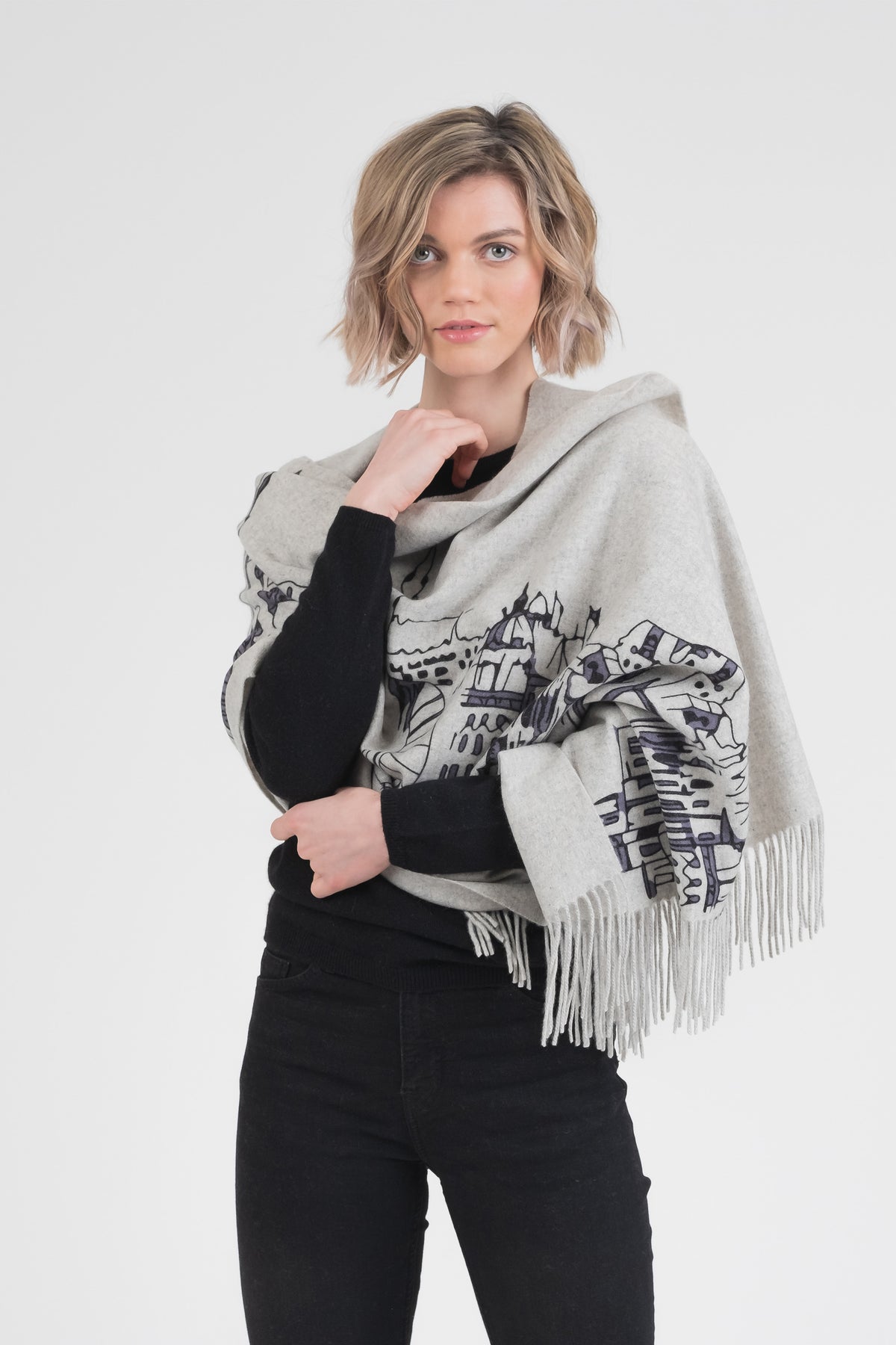 Skyline Cashmere Double Sided Stole in grey with hand-printed Edinburgh skyline illustration, fringed edges, worn draped over shoulders