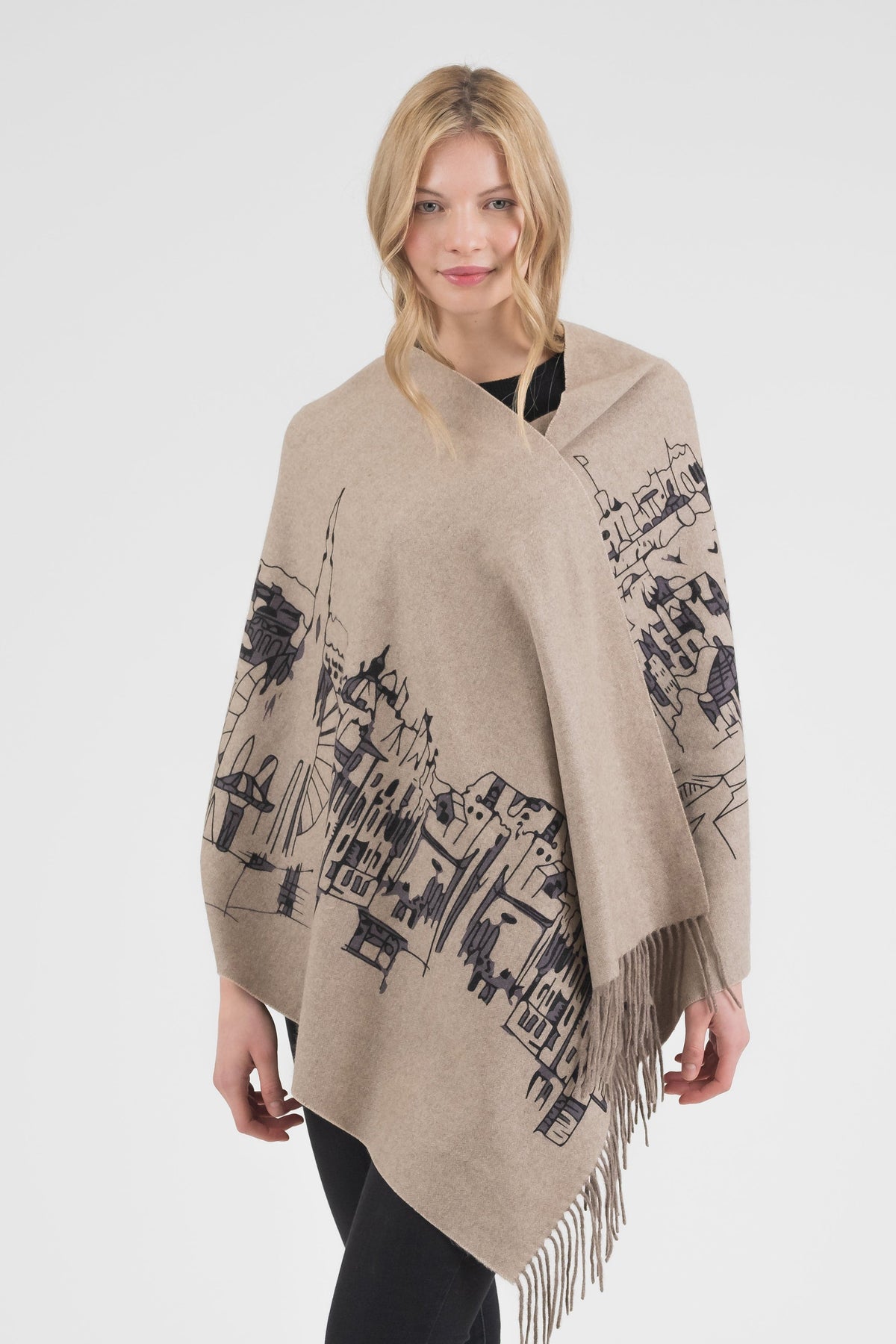 Skyline Cashmere Double Sided Stole in beige with black handprinted cityscape illustration, fringed edges, worn as a wrap