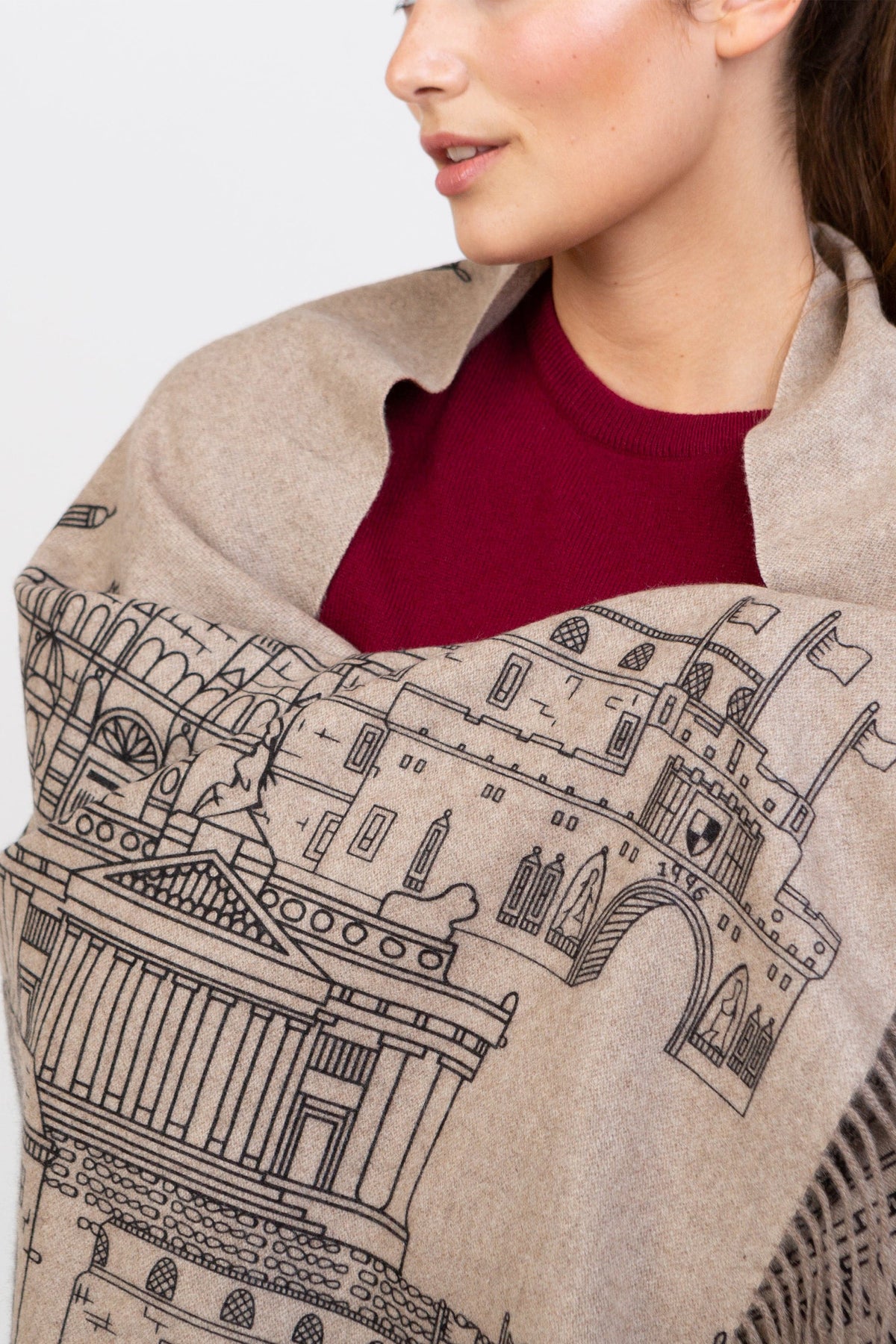 Close-up of Skyline Cashmere Double Sided Stole in beige showing detailed architectural cityscape print with fringed edge