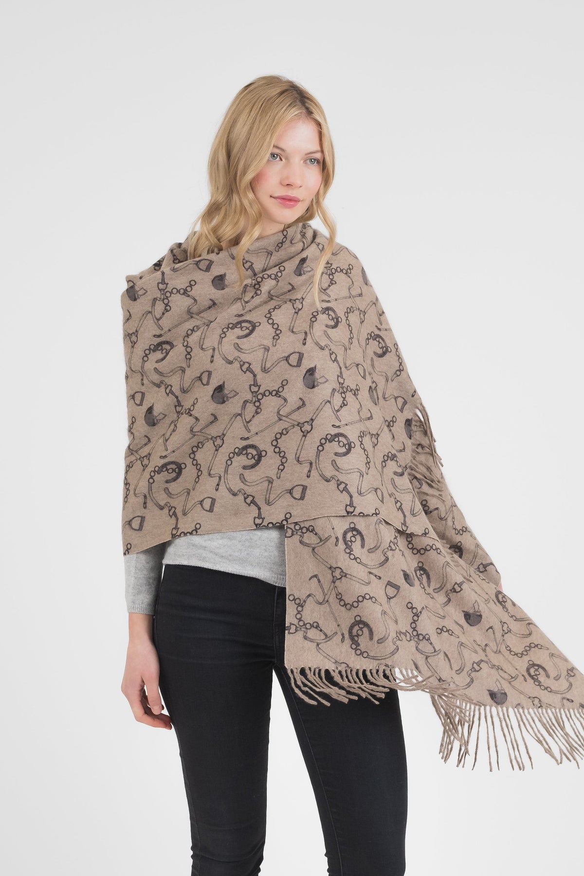 Equestrian Cashmere Double Sided Stole in beige with dark equestrian print, fringed edges, draped over shoulders