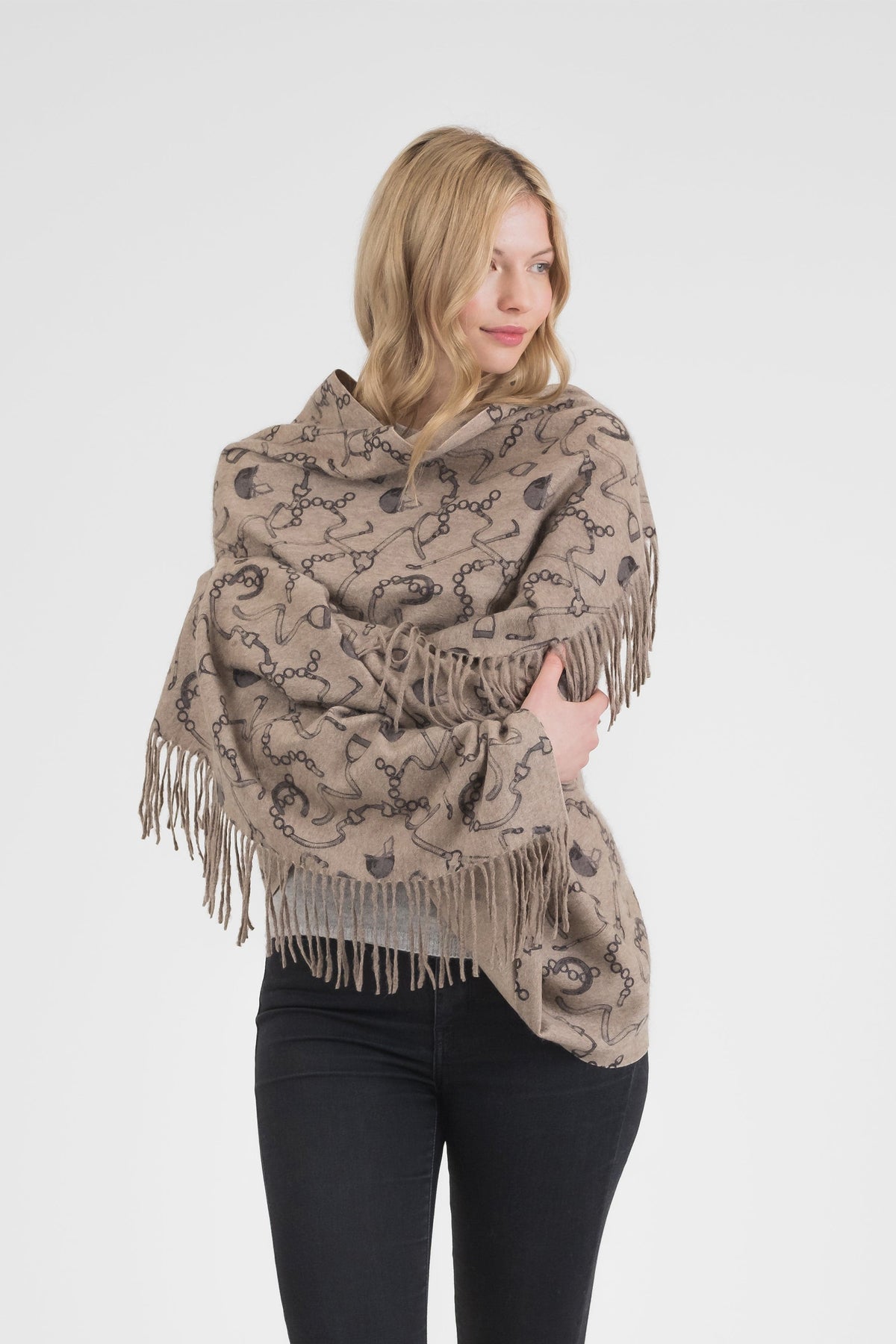 Model wearing the Equestrian Cashmere Double Sided Stole in Beige draped over shoulders, showing horse-bit print and fringe detail