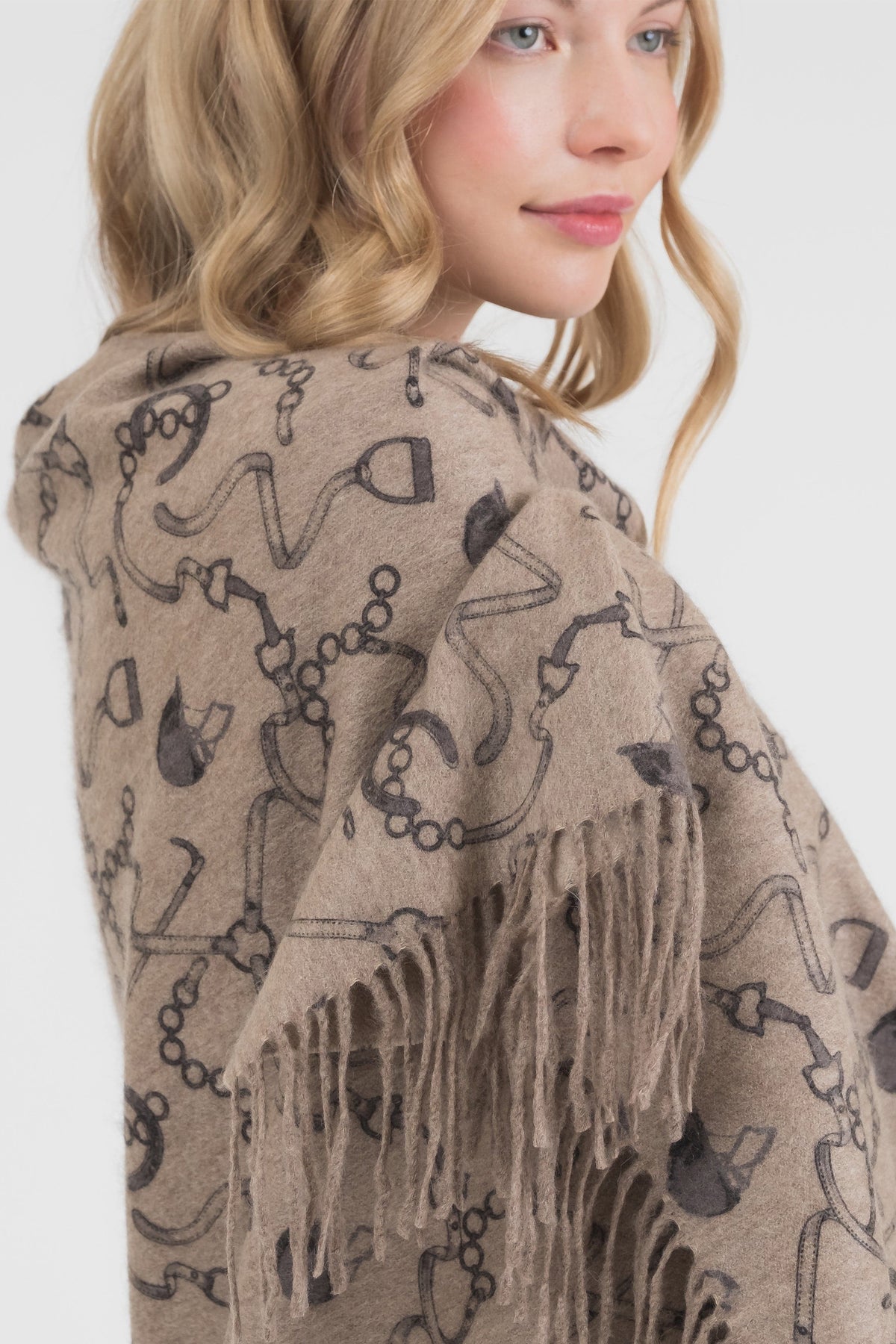 Close-up of Equestrian Cashmere Double Sided Stole in beige showing chain and bridle print detail with fringed edge