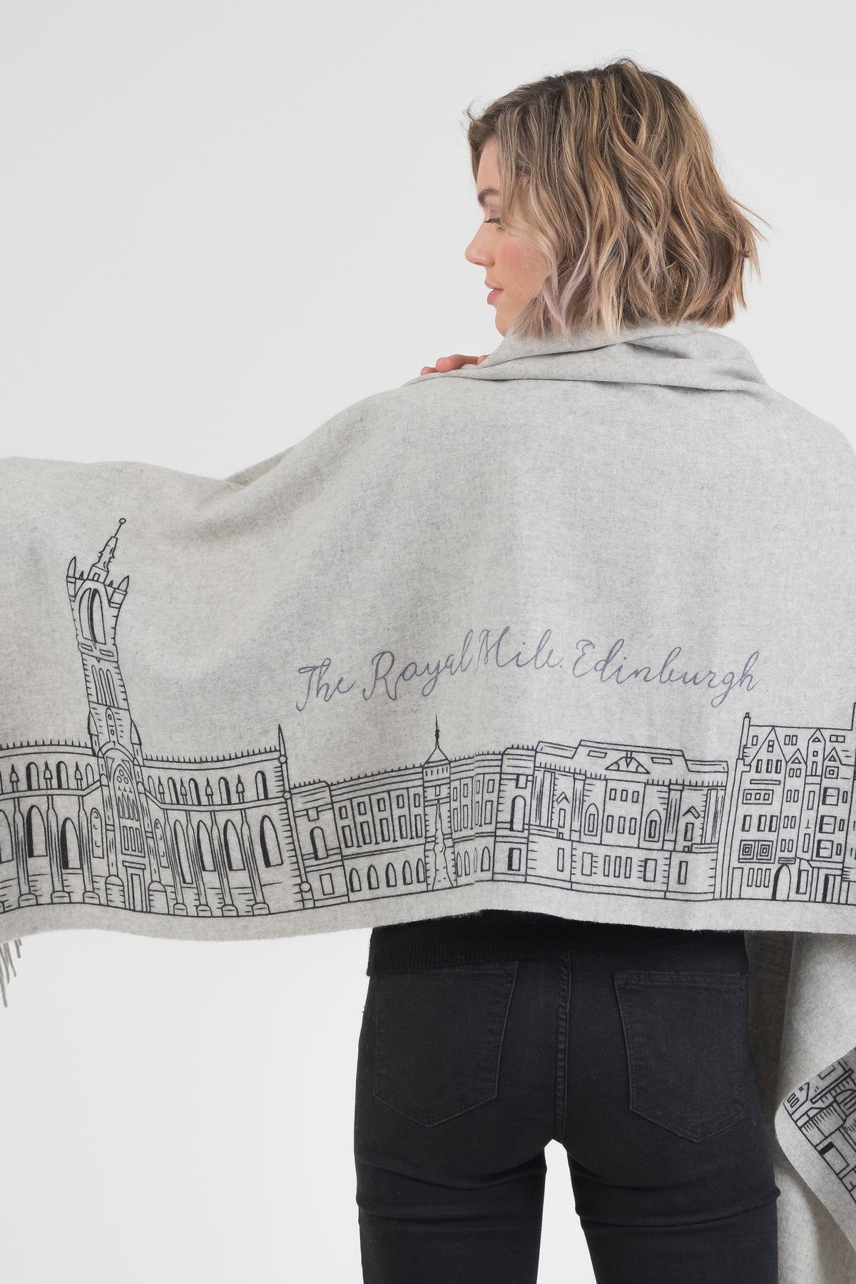 Back view of Royal Mile Cashmere Double Sided Stole in grey, showing Edinburgh Royal Mile skyline illustration draped across shoulders