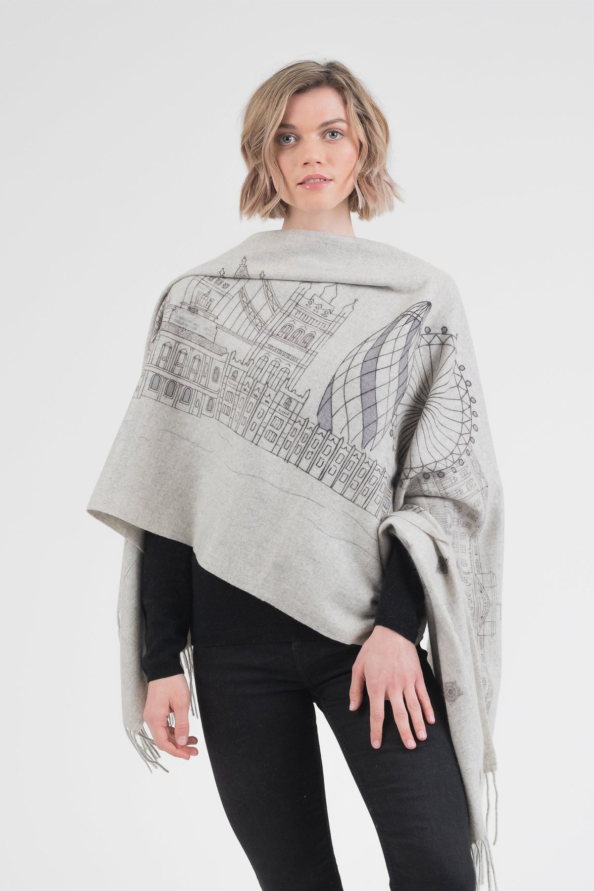 City Cashmere Double Sided Stole - London in grey, worn draped over shoulders showing London skyline illustration with The Gherkin and landmarks