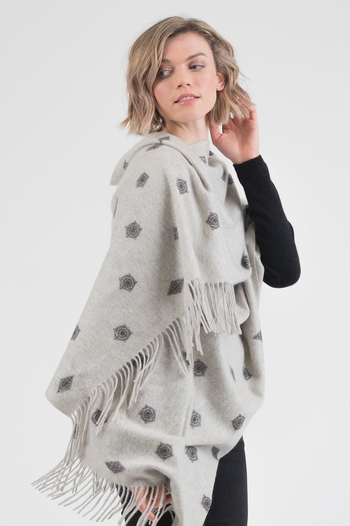City Cashmere Double Sided Stole - Windsor Castle in light grey with geometric motif pattern, styled as a wrap showing fringed edges