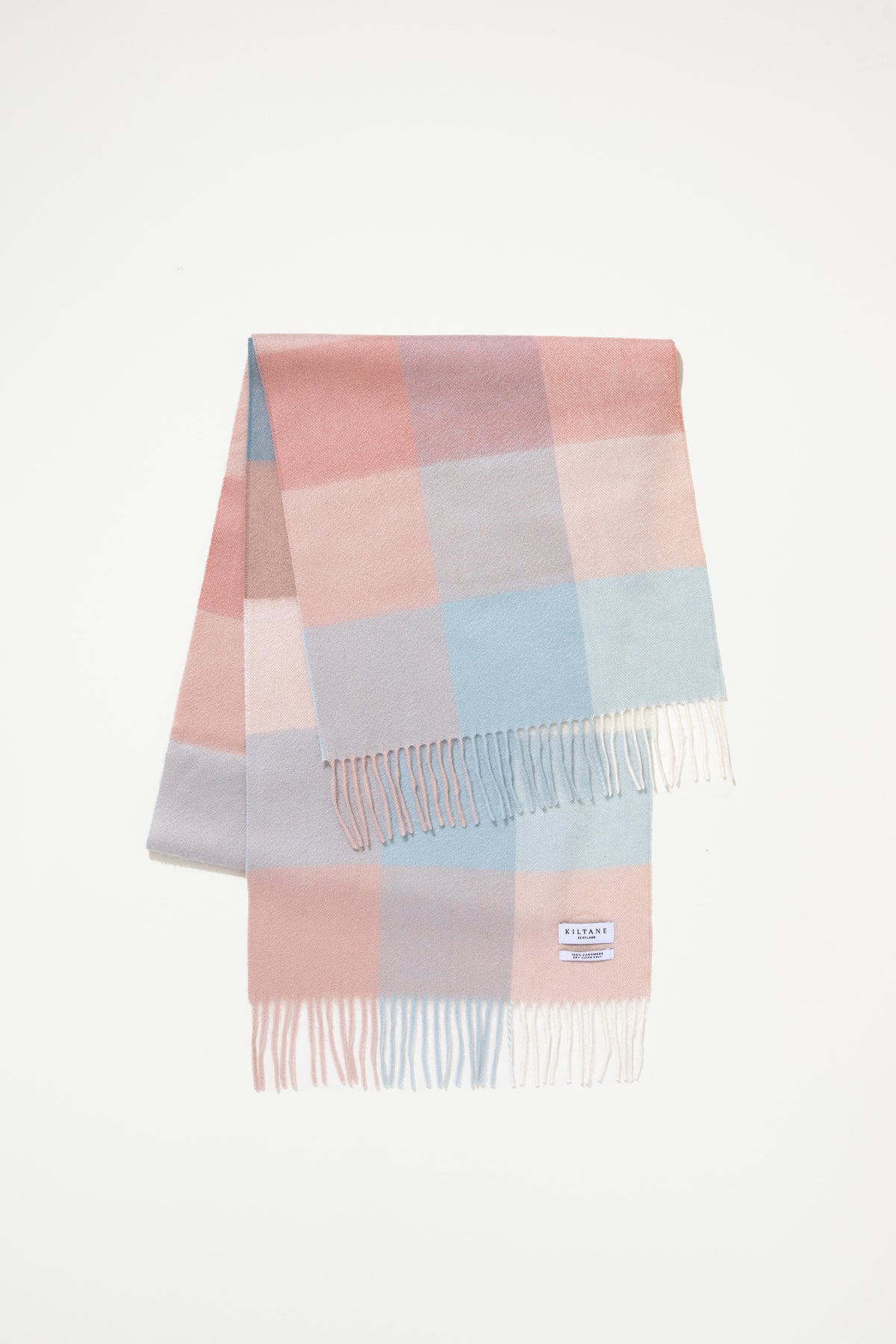 Kiltane 3 Square Check Cashmere Wide Scarf in Seashell, folded flat showing pastel pink, blue, and grey check pattern with fringe
