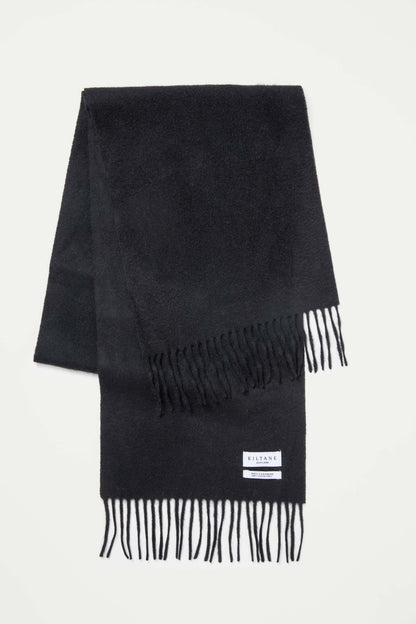 Kiltane Scotland Solid Cashmere Scarf in black, folded flat showing soft texture, fringed ends, and brand label