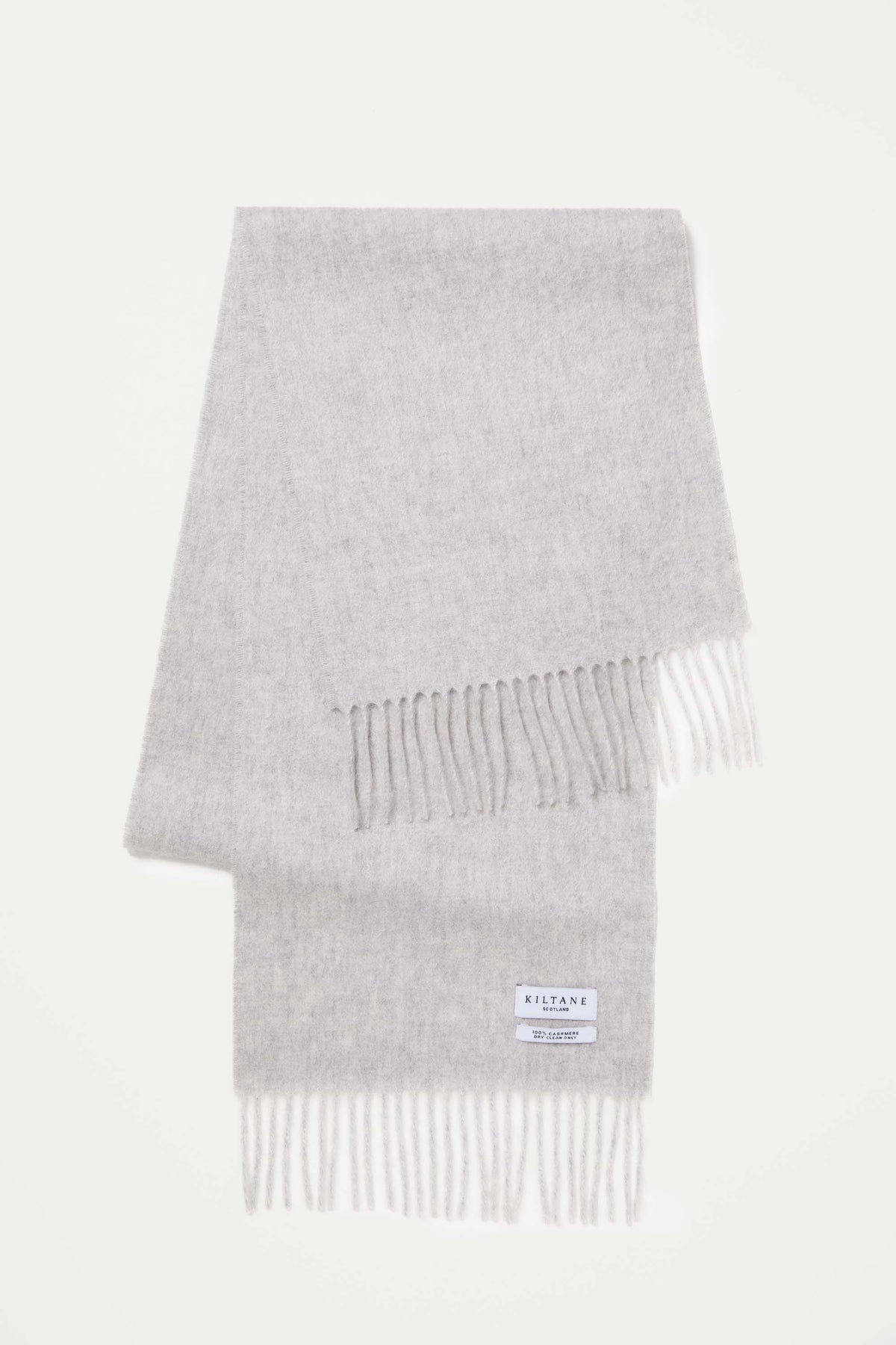Kiltane Solid Cashmere Scarf in Oyster Grey folded flat showing fringed ends and brand label with 100% cashmere tag