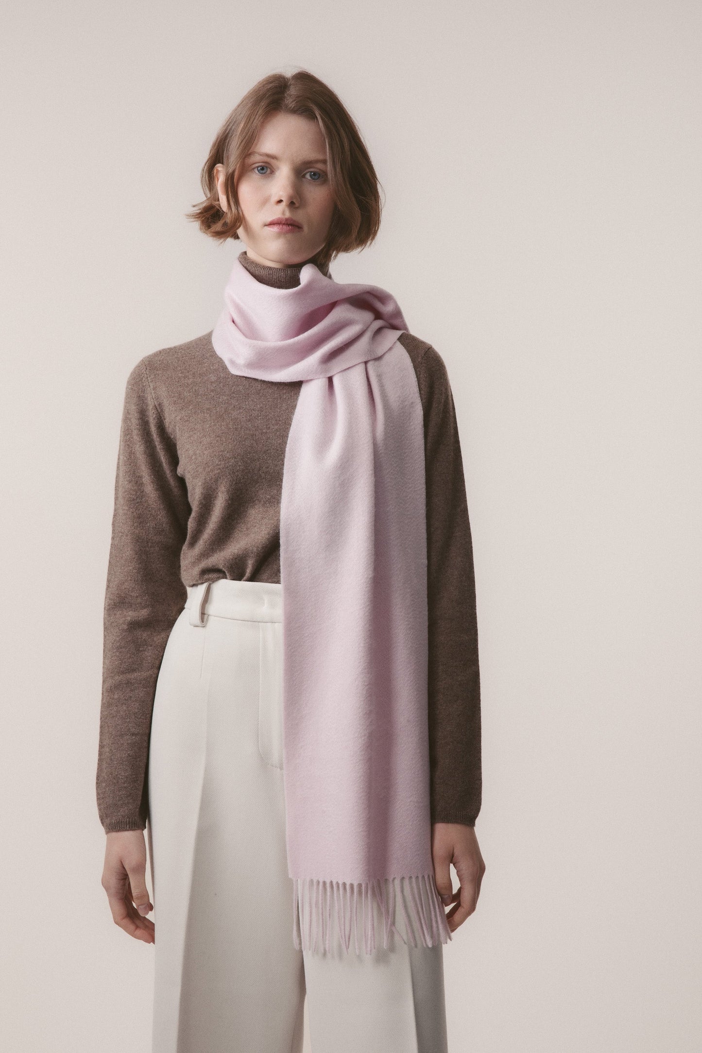 Solid Cashmere Scarf in Pale Lilac worn looped around the neck with fringed ends draping down the front