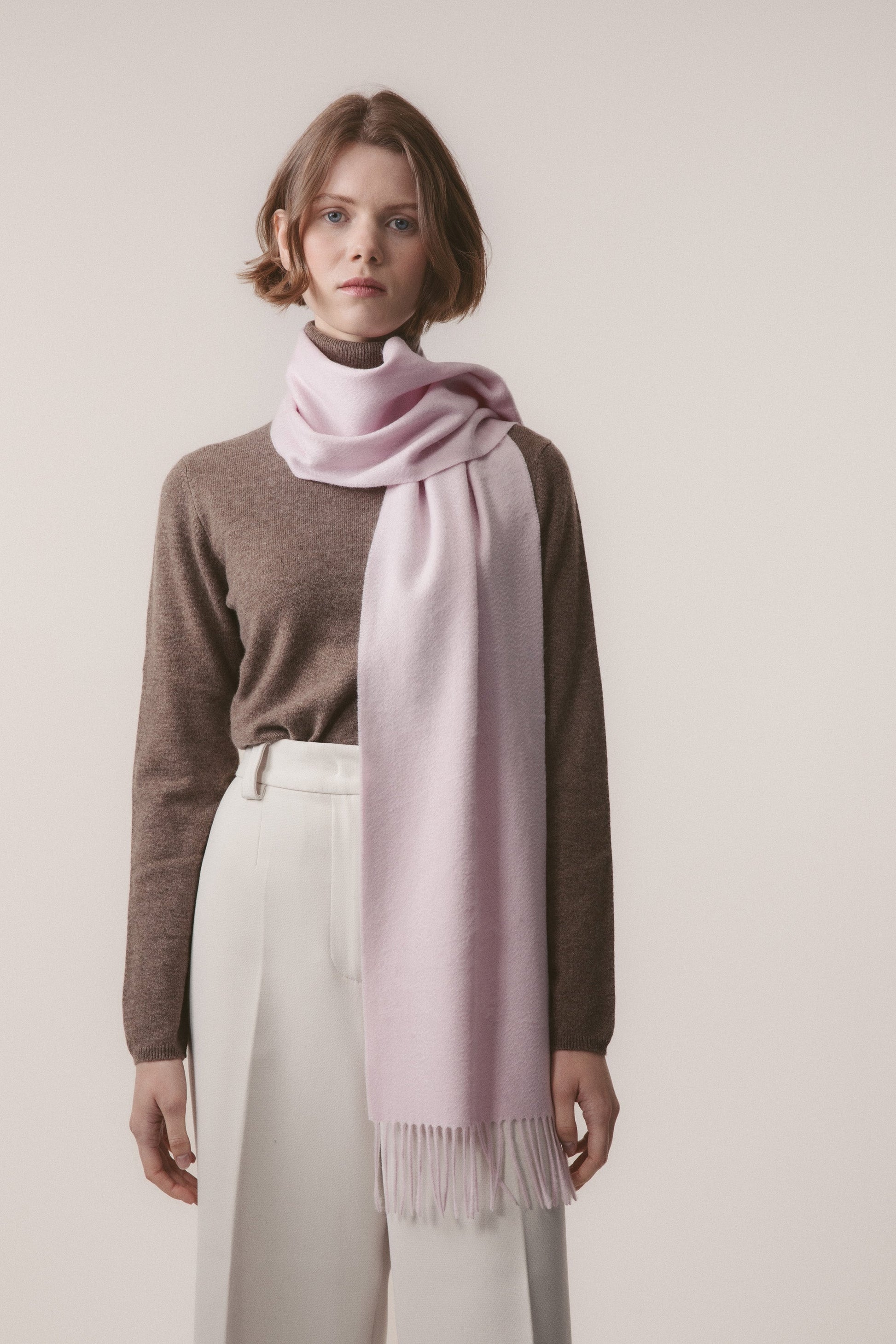 Solid Cashmere Scarf in Pale Lilac worn looped around the neck with fringed ends draping down the front