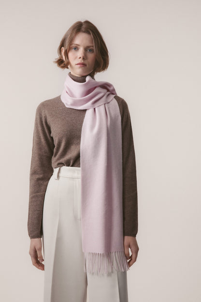 Solid Cashmere Scarf in Pale Lilac worn looped around the neck with fringed ends draping down the front