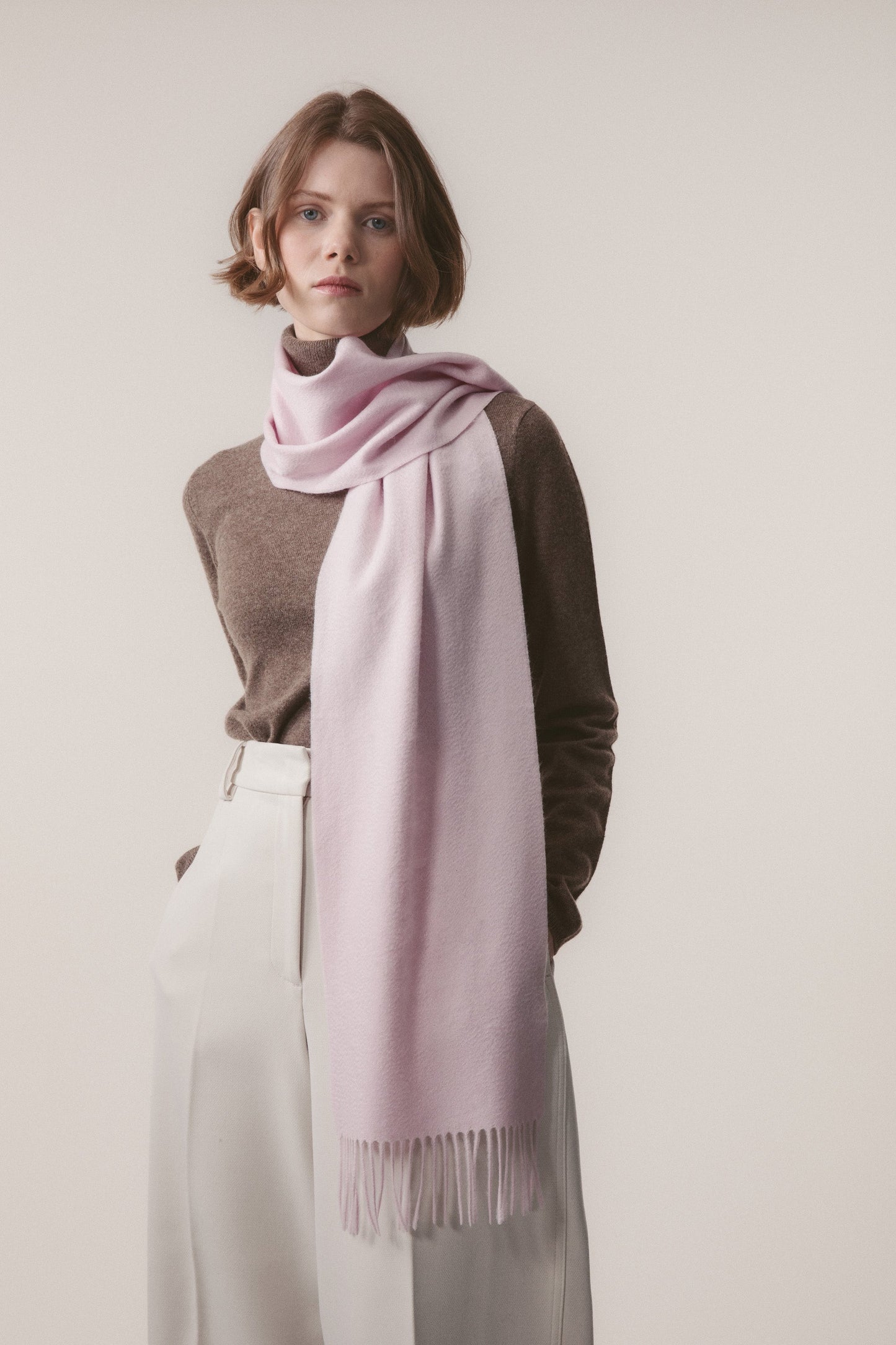 Solid Cashmere Scarf in Pale Lilac worn loosely draped around the neck, showing soft texture and fringed ends