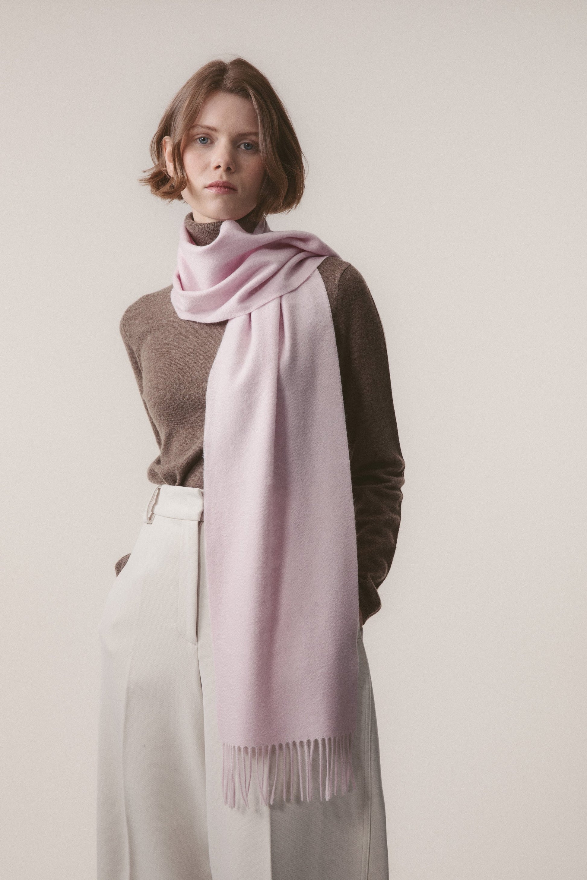 Solid Cashmere Scarf in Pale Lilac worn loosely draped around the neck, showing soft texture and fringed ends