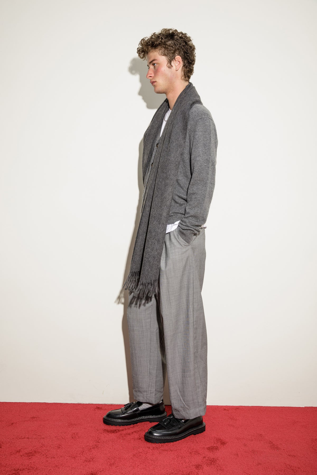 Solid Cashmere Stole in Steinway Grey shown draped over shoulders in side profile, highlighting fringed ends and soft drape