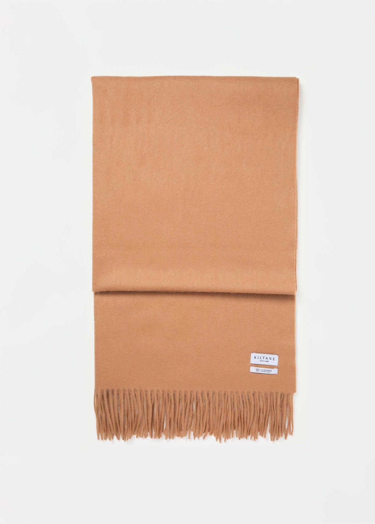 Kiltane Solid Cashmere Stole in Dark Camel folded flat showing brand label and fringed edge detail