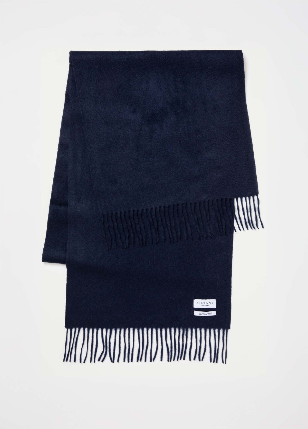 Kiltane Solid Cashmere Wide Scarf in Dark Navy folded flat showing fringed ends and brand label