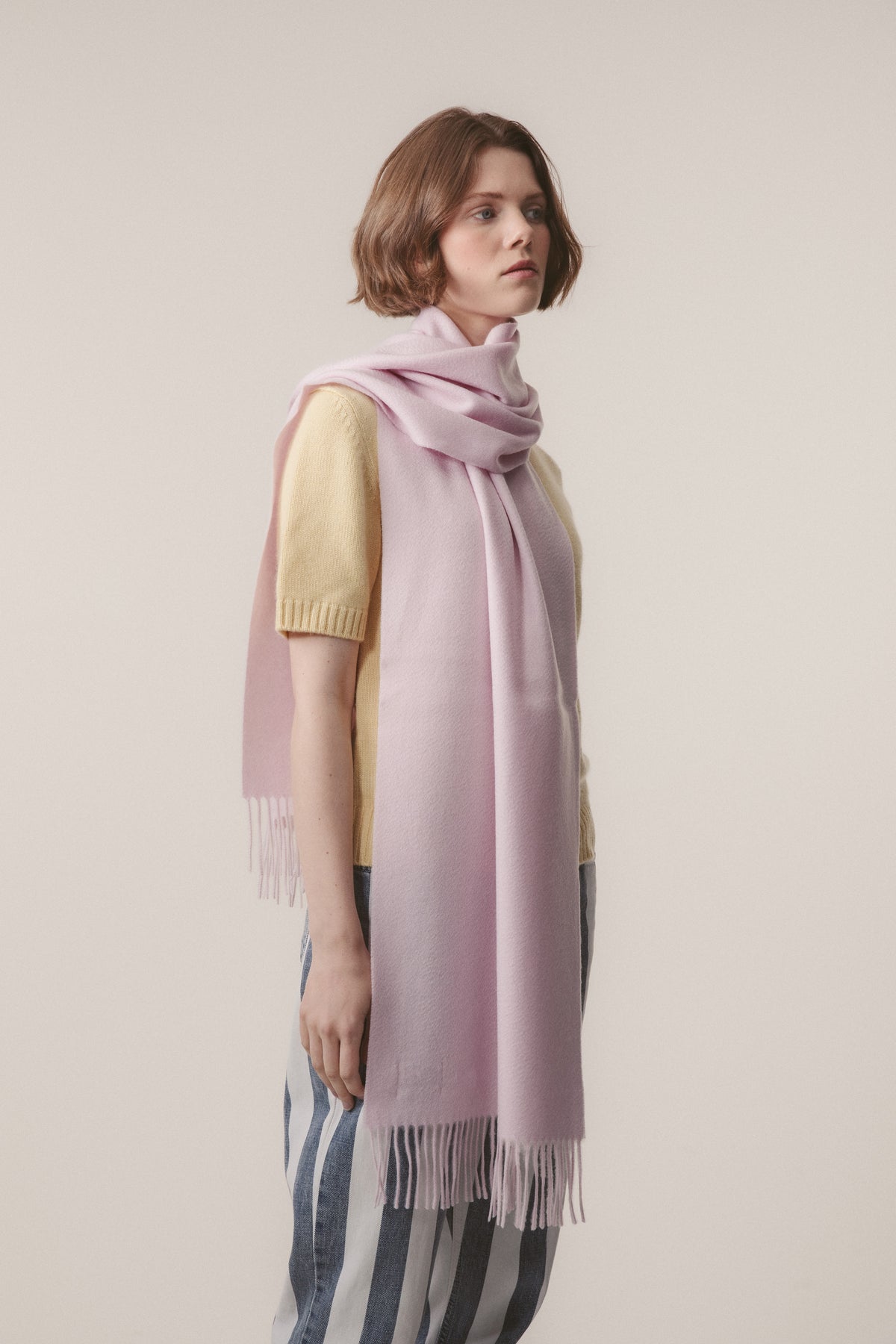 Solid Cashmere Wide Scarf in Lilac worn loosely draped around the neck, showing the soft drape and fringed ends