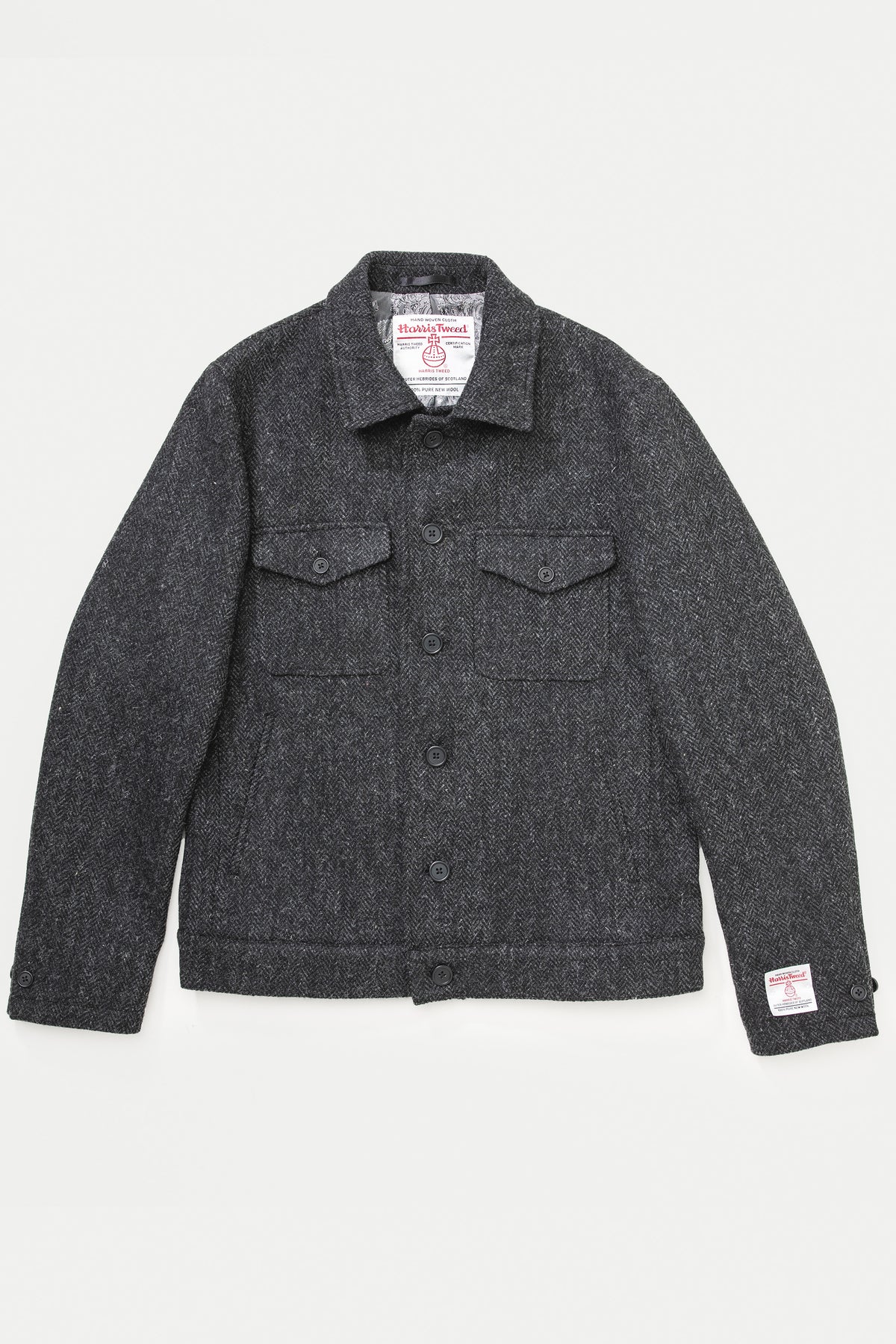 Men's Harris Tweed Sergeant Jacket in deep charcoal herringbone, front view showing dual chest pockets and button closure