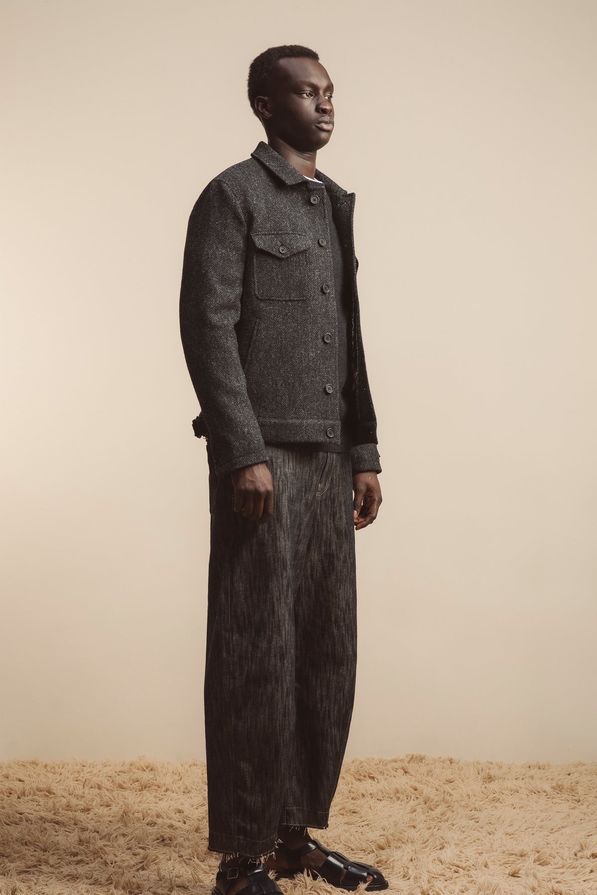 Men's Harris Tweed Sergeant Jacket in Deep Charcoal, three-quarter view showing button-front closure and chest flap pocket