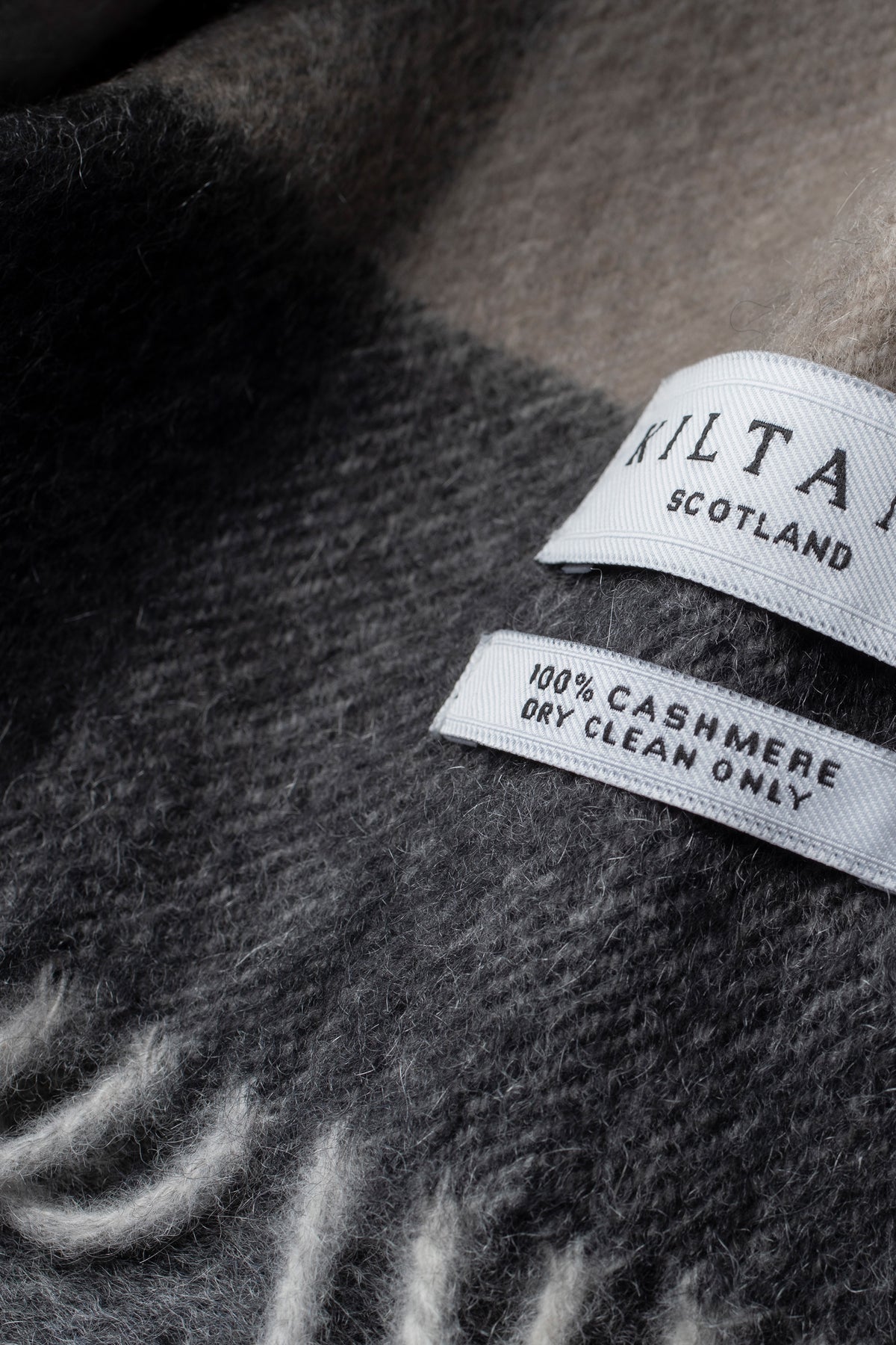 Close-up of Kiltane Scotland label on 5 Square Check Cashmere Scarf showing 100% cashmere and dry clean only care detail