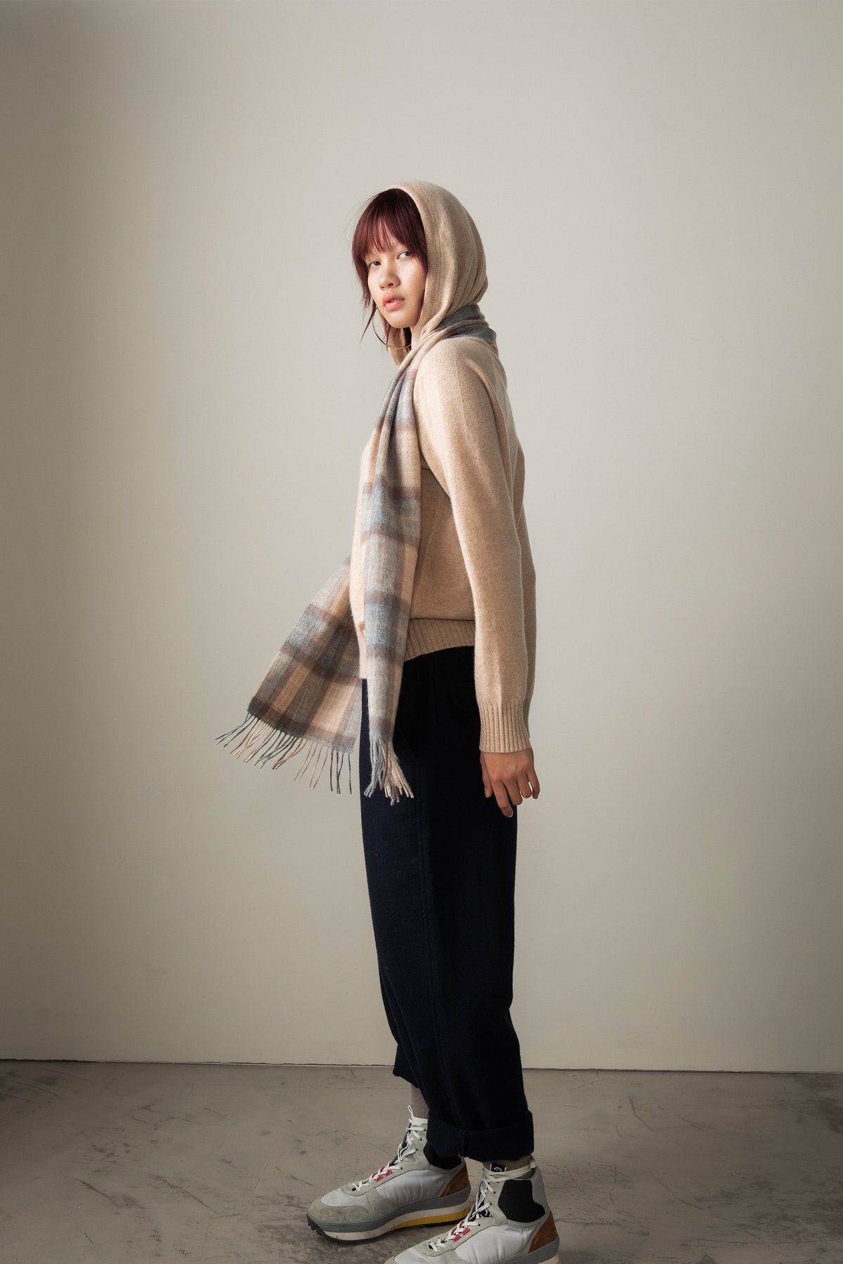 Heritage Tartan Cashmere Scarf - Mackellar Natural worn as a headscarf, showing plaid pattern with fringed ends draping at the front