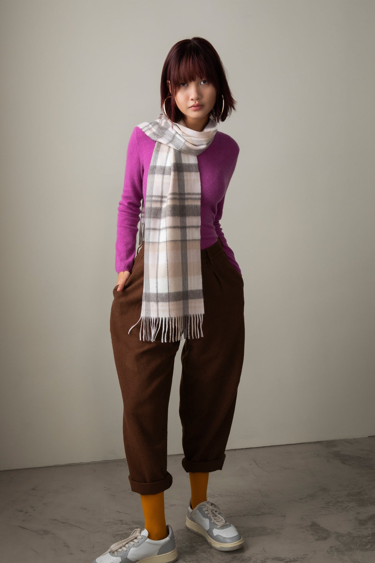 Square Check Cashmere Scarf in Natural, cream and grey plaid with fringed ends, styled draped over a purple sweater