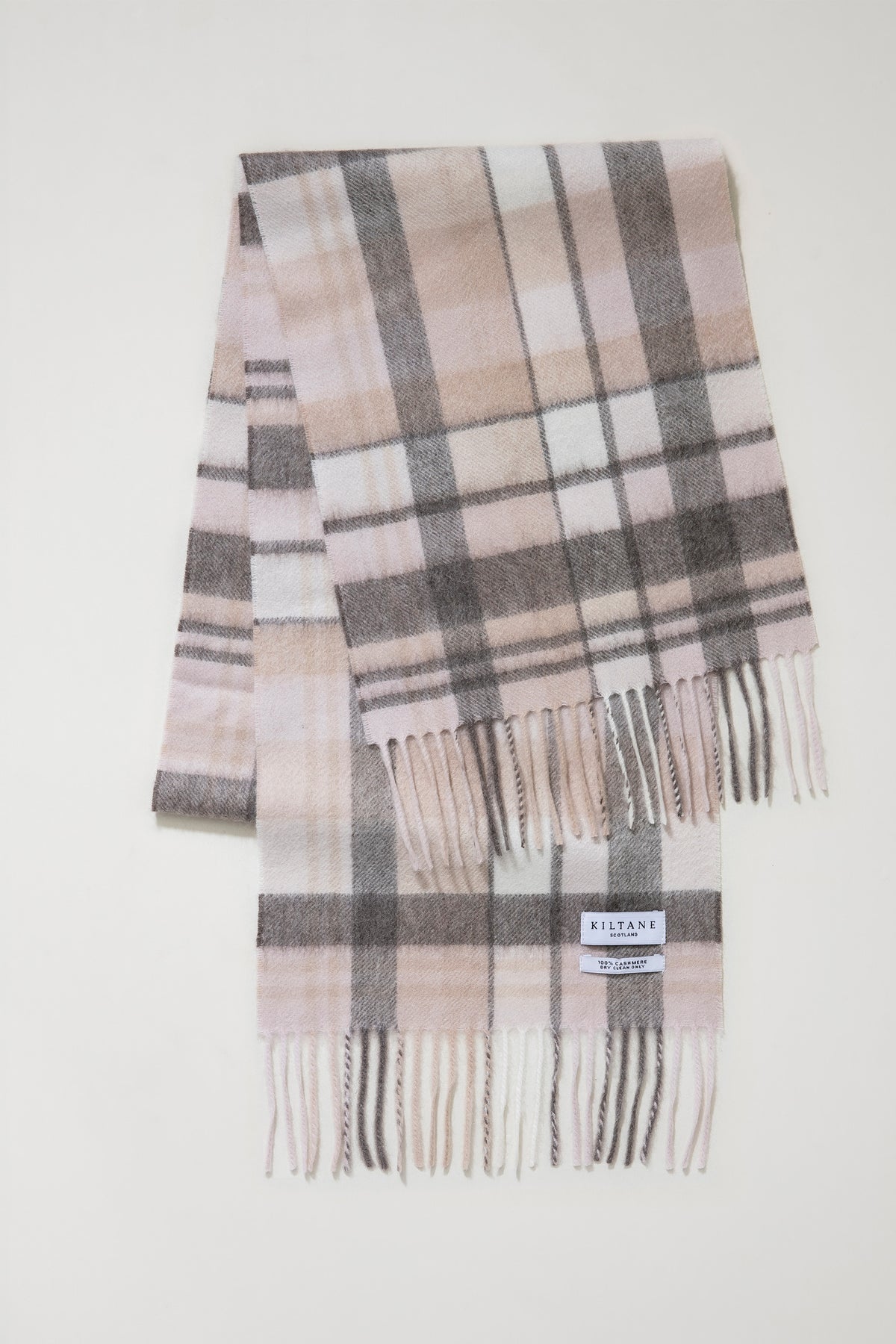 Kiltane Square Check Cashmere Scarf in Natural folded flat showing full plaid pattern in pink, grey, and cream with fringed ends