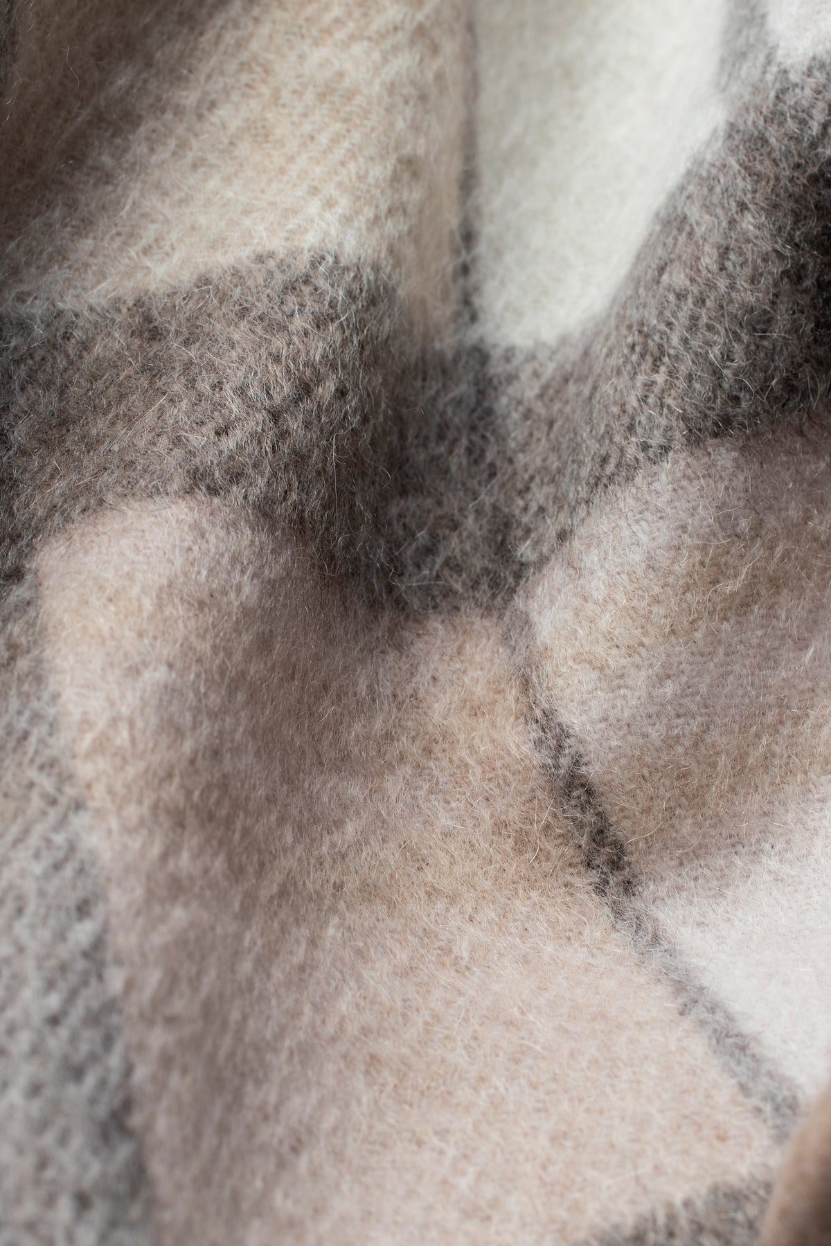 Close-up of Square Check Cashmere Scarf in Natural showing soft brushed texture and plaid pattern in beige, cream, and charcoal