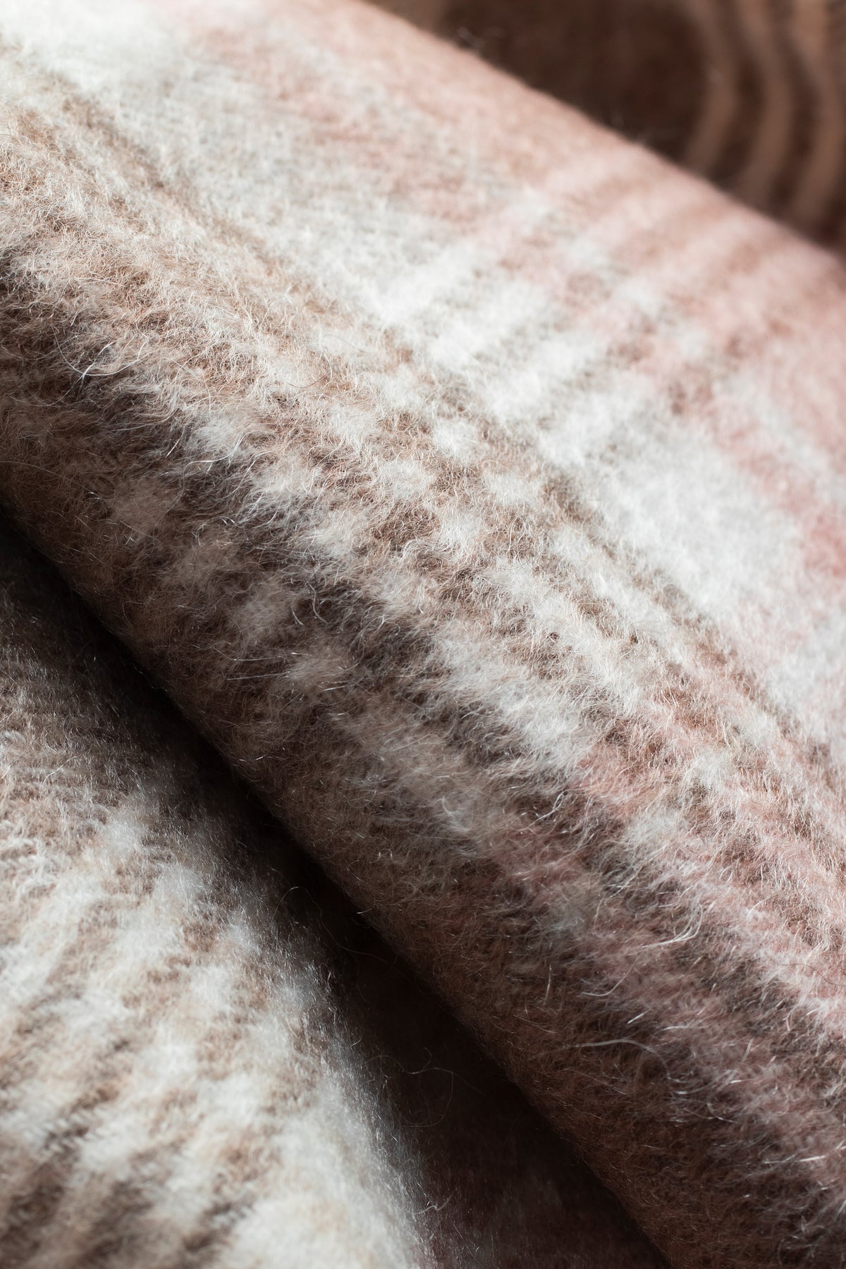 Close-up of Repeat Edge Cashmere Scarf in Natural showing soft brushed texture with brown, cream, and pink plaid pattern