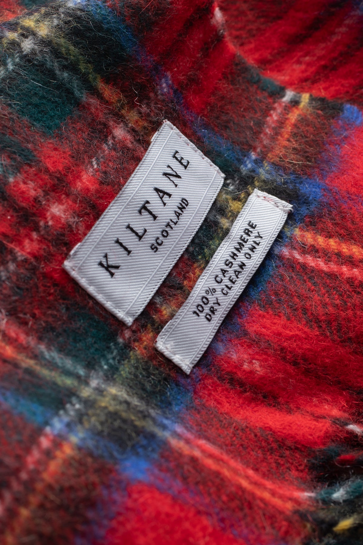 Close-up of Kiltane Scotland label on Heritage Tartan Cashmere Scarf showing 100% cashmere, dry clean only care details