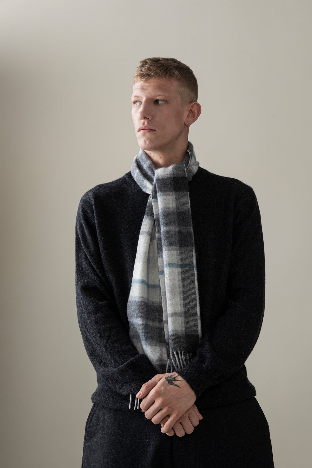 Contemporary Check Cashmere Scarf in Ashley Blue worn loosely draped around the neck, showing plaid pattern and fringed ends