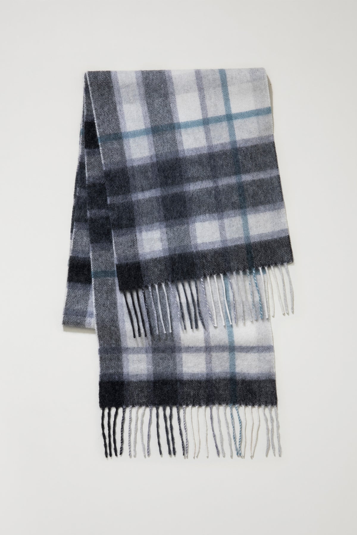 Contemporary Check Cashmere Scarf in Ashley Blue folded flat showing full plaid pattern in grey, charcoal, and blue with fringed ends