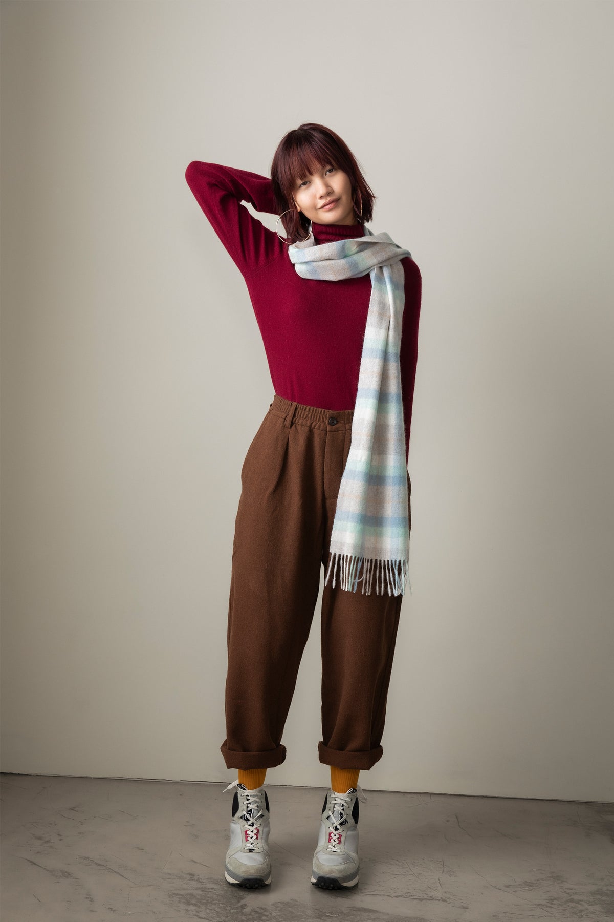 Contemporary Check Cashmere Scarf in Aqua styled on model, soft plaid pattern in light blue and cream tones with fringed ends