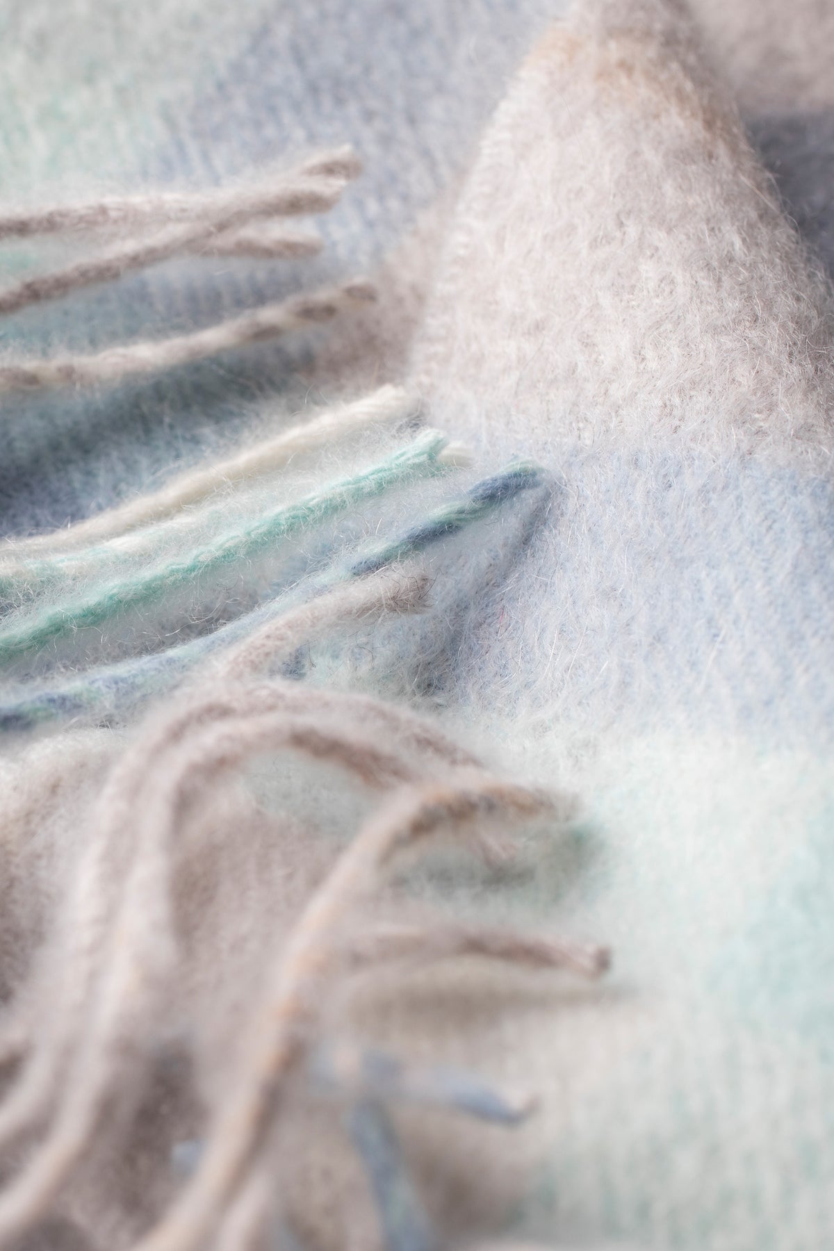 Close-up of Contemporary Check Cashmere Scarf in Aqua showing soft brushed texture and taupe fringe detail