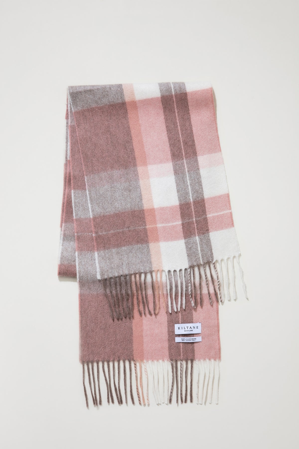 Kiltane Contemporary Check Cashmere Scarf in Cameo folded flat showing pink, white, and brown plaid pattern with fringed ends