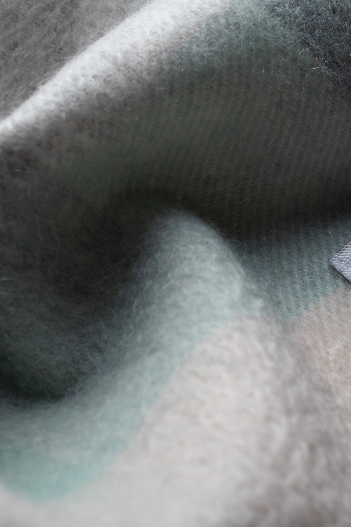 Close-up of 5 Square Check Cashmere Scarf in Brume showing soft brushed texture in muted green and grey tones