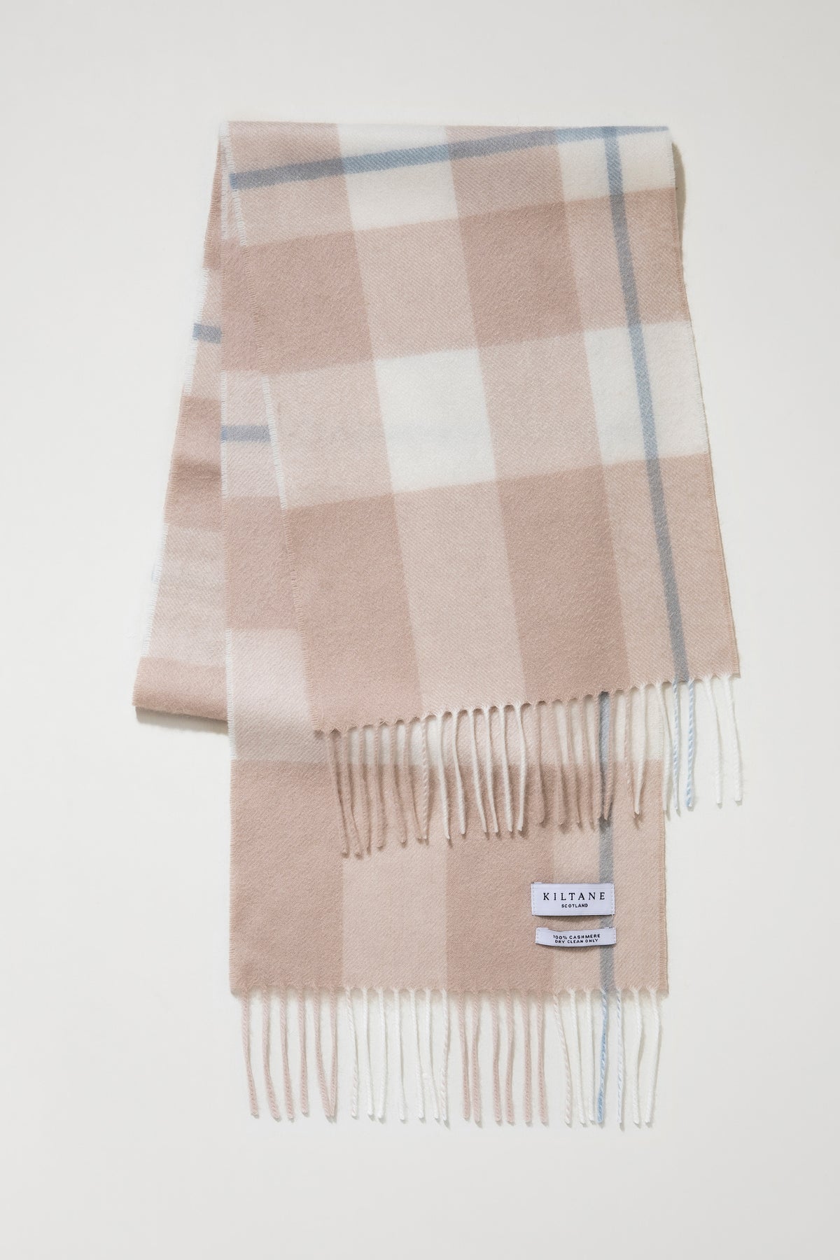 Kiltane Scotland label and fringed ends of the Contemporary Check Cashmere Scarf in Champagne Pink, showing 100% cashmere tag