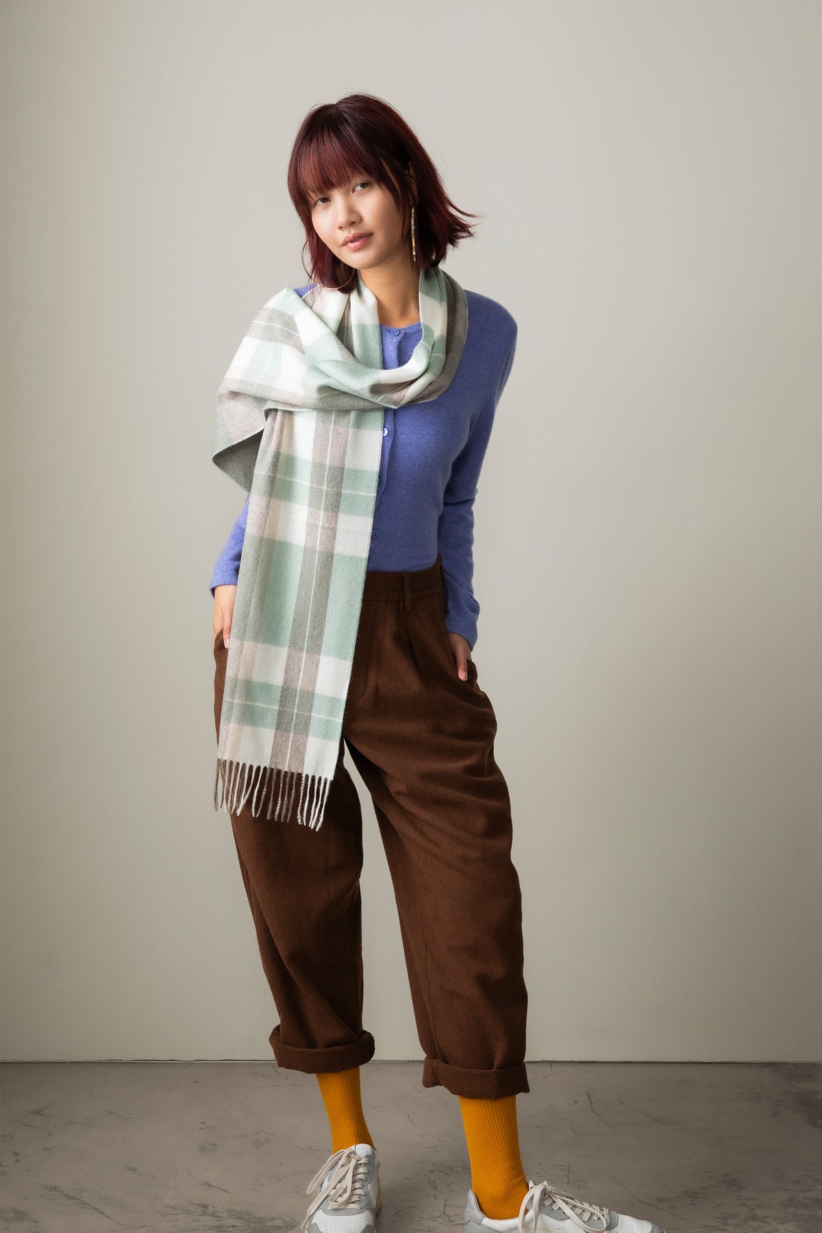 Contemporary Check Cashmere Scarf in Seafoam, mint green and beige plaid with fringed ends, worn draped over a blue sweater