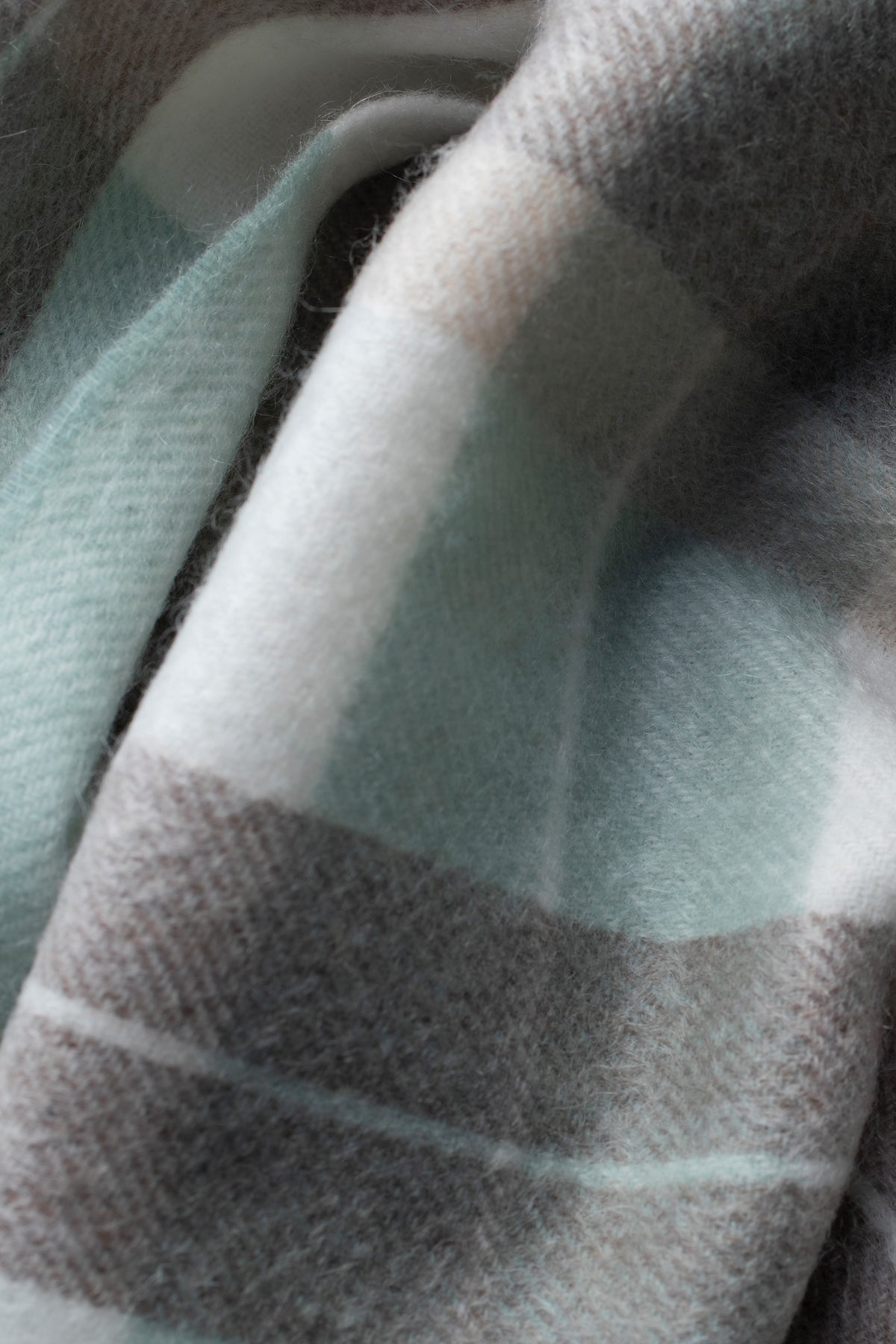 Close-up of Contemporary Check Cashmere Scarf in Seafoam showing soft brushed texture with mint green, grey, and cream plaid pattern