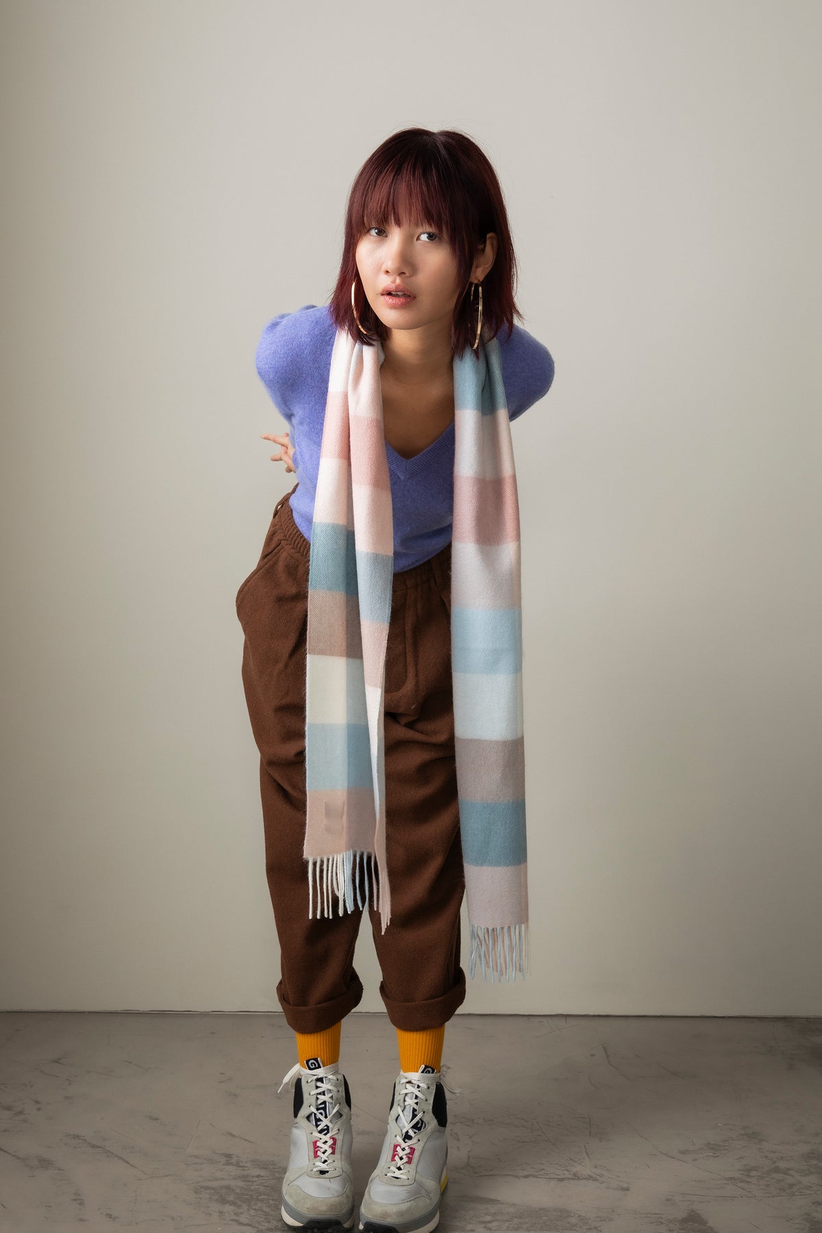 3 Square Cashmere Scarf in Seashell worn draped over shoulders, featuring pastel pink, blue, and cream stripes with fringed ends