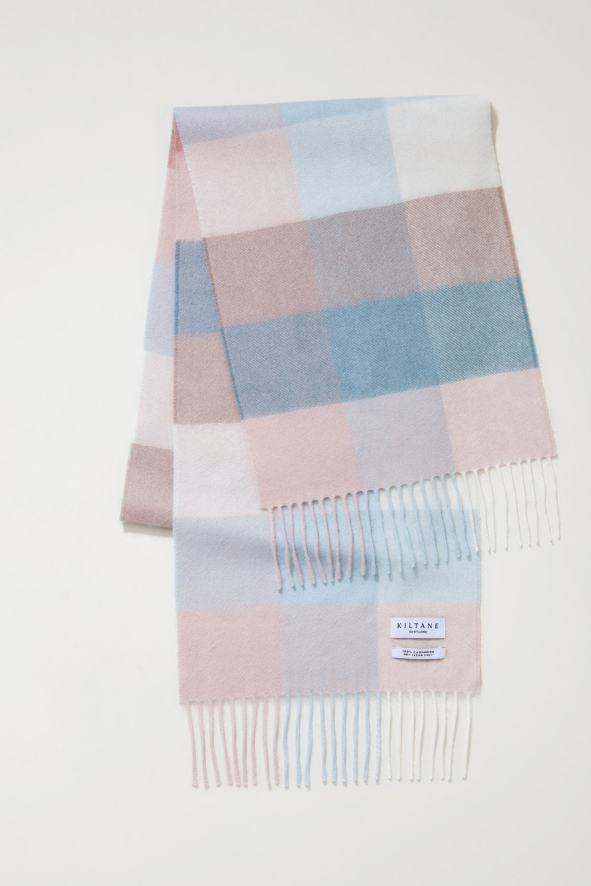 3 Square Cashmere Scarf in Seashell colourway folded flat showing full check pattern in pink, blue, and lilac with fringed ends